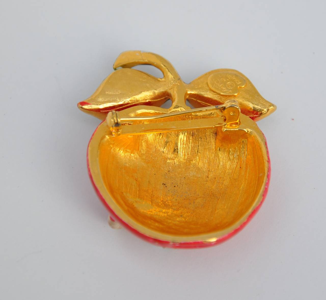 This wonderfully detailed "Apple with Worm" Gilded gold vermeil finished with enamel in red, green, brown and cream designed by "Original by Robero" measures 2" in height, 1 5/8" in width and 5/8" in depth. This