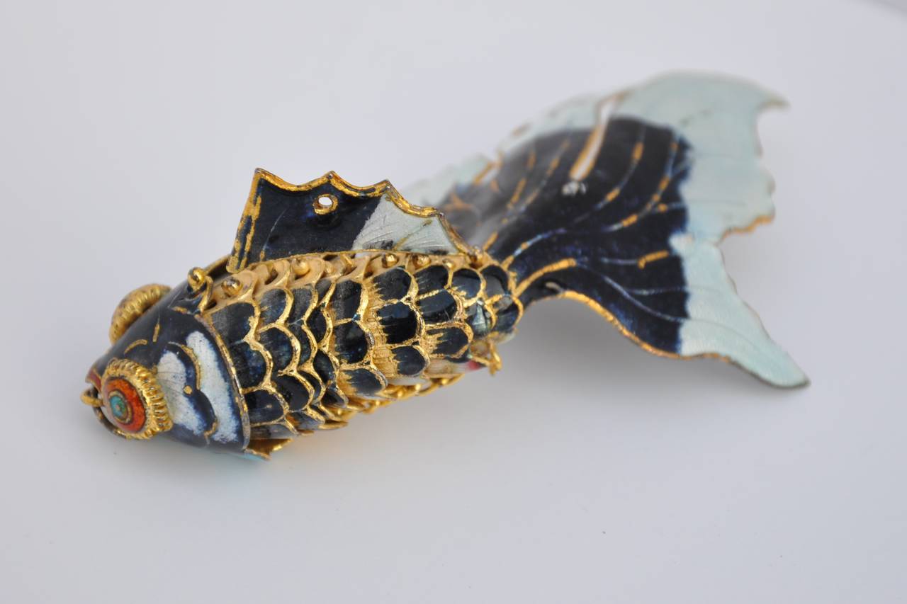 This wonderfully detailed Japanese gold hardware accented with multi-color enamel "Fish" pendant, is movable and elegantly dangles. The length measures 4 3/4", width measures 2", depth is 2 3/4".