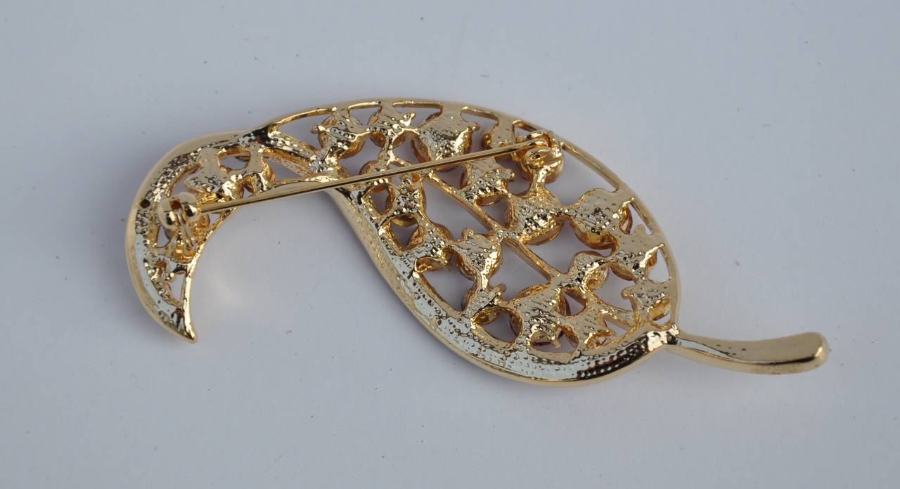 This wonderfully detailed gilded gold vermeil finish accented with multi-shades of violet "Leaf" brooch measures 1 1/2" in height, 2 6/8" in width and 3/8" in depth.