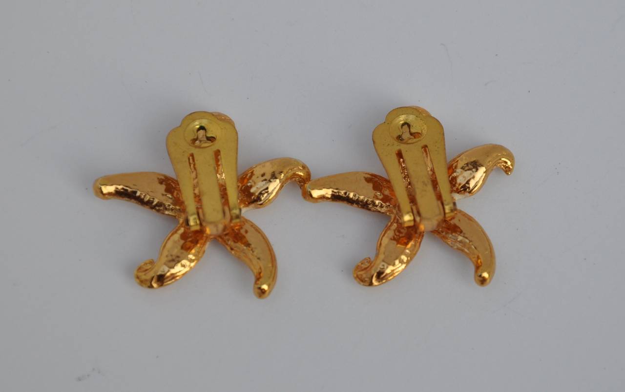 Gilded gold vermeil finish accented with enamel "Starfish" earrings measures 1 1/8" in length, 1 1/8" in height and 3/8" in depth.