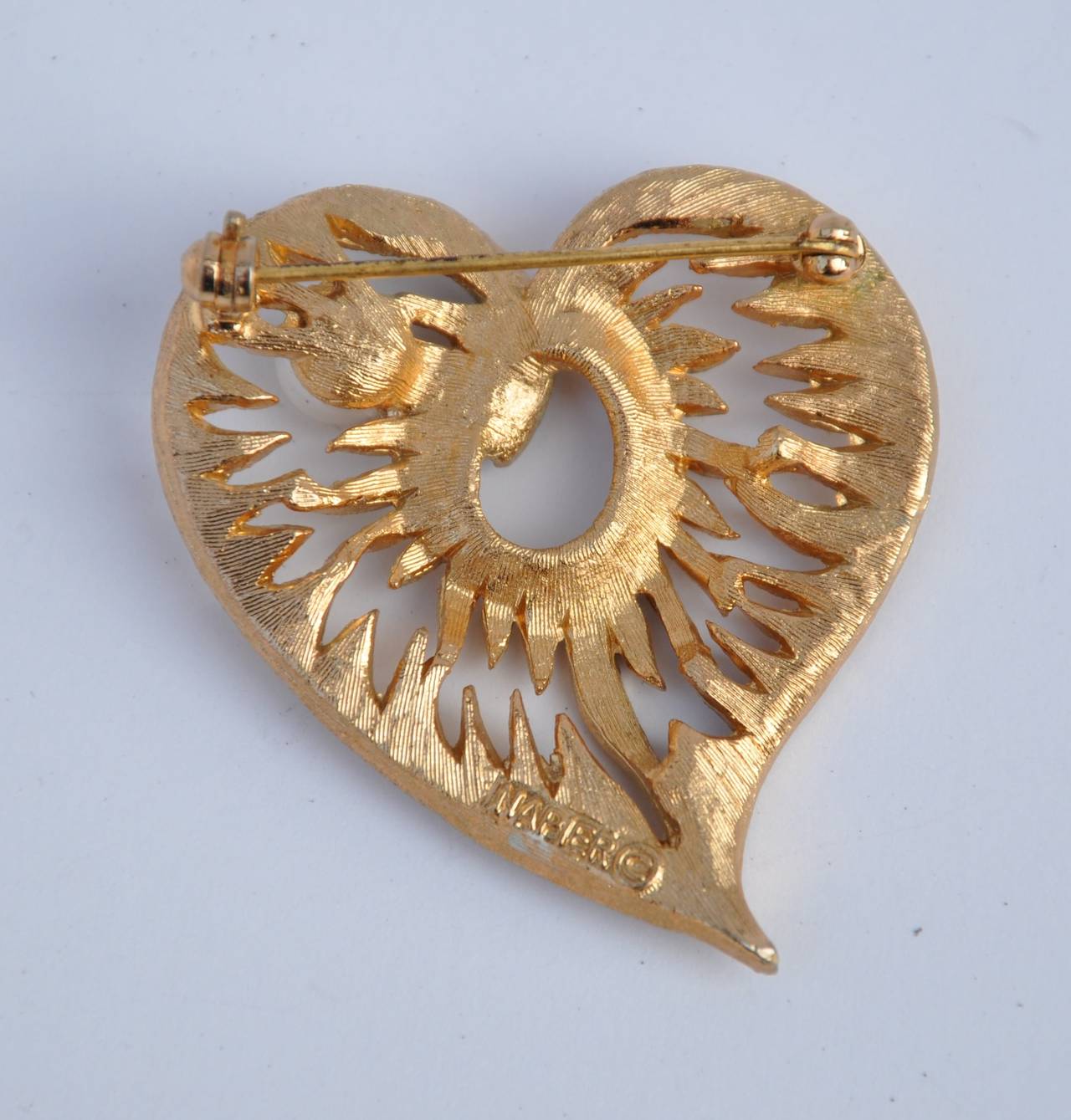 Napier gilded gold with filigree finish hardware brooch accented with a pearl "Heart" measures 1 3/4" in height, width is 1 5/8", depth is 2/8".