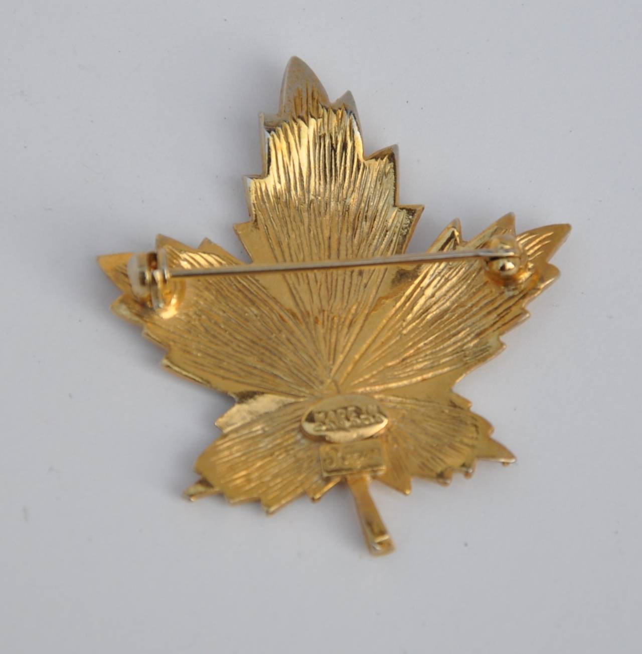 Keyes wonderfully detailed gilded gold hardware "Leaf" brooch measures 1 7/8" in length, 1 5/8" in width and 1/8" in depth.