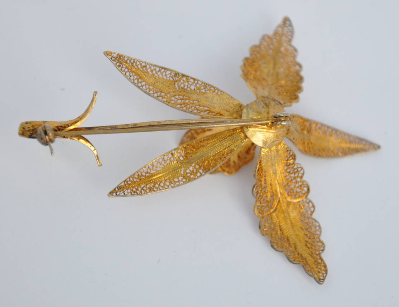 This wonderfully detailed gilded gold filigree "Orchid" brooch measures 3 1/4" in length, 2 5/8" in height and 1" in depth.