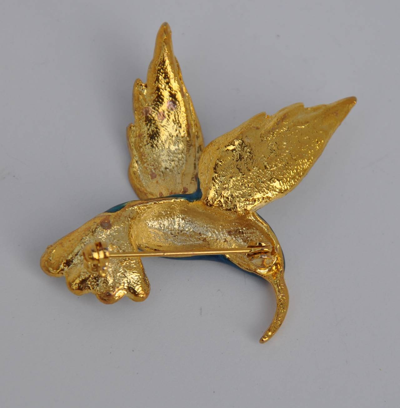 Gilded gold vermeil accented with multi-color enamel "Humming Bird" brooch measures 1 5/8" in length, 1 6/8" in height and 1/2" in depth.