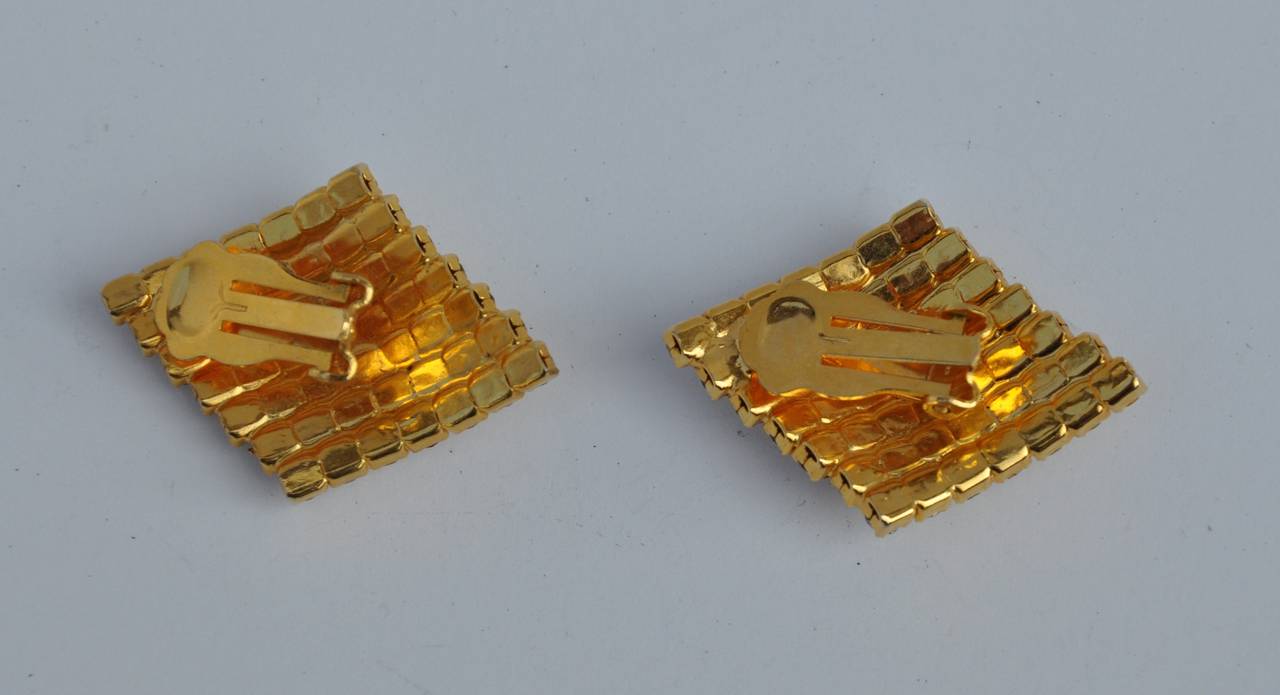 These wonderful gilded gold set with rhinestones ear clips measures 1 1/2" in length, 1 1/8" in width and 3/8" in depth.