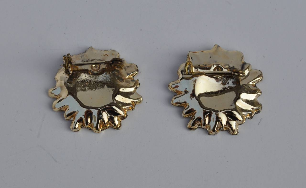 This wonderful pair of gilded gold hardware accented with cream enamel floral brooches can be used on sweaters, hats, or a favorite pair of shoes if desired. The width measures 1 1/8", height is 1", depth is 2/8".