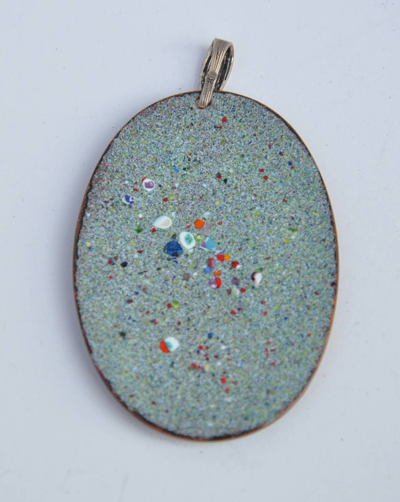      Multi-colors of baked enamel into a wonderful floral design pendant measures 2" in height and 1 1/2" in width.