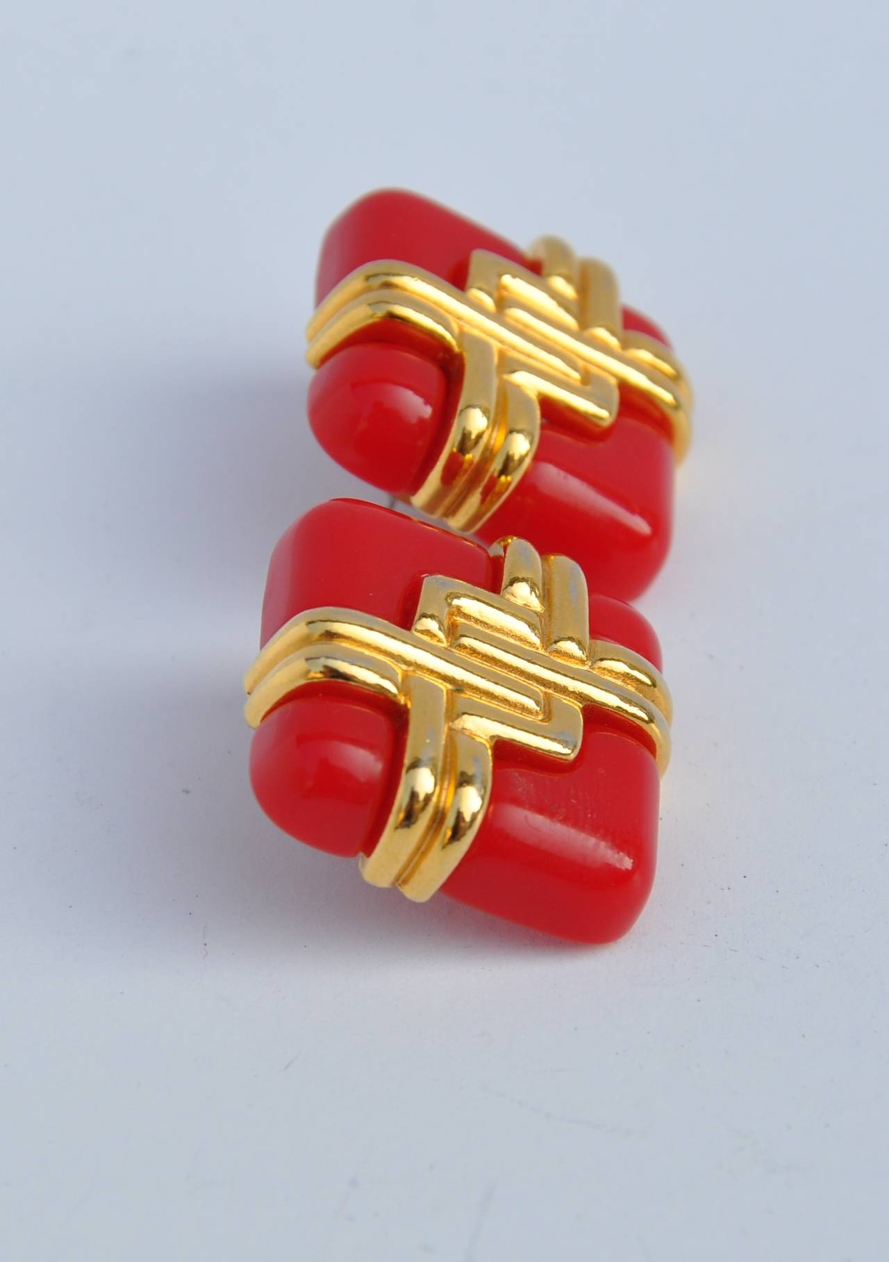 These interchangeable "Set of Three" earrings of gilded gold with a choice of red, black or blue lucite measures 1 1/16" x 1 1/16" when placed together. The lucite separates measures 1" x 1" each.