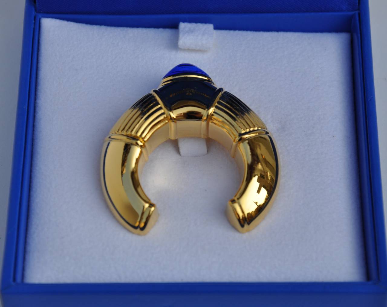 Boucheron signature gilded gold vermeil finish hardware with "Lapis" hue accent brooch measures 1 7/8" in height, 1 5/8" in width and 3/8" in depth. Brooch is signed on the backside.