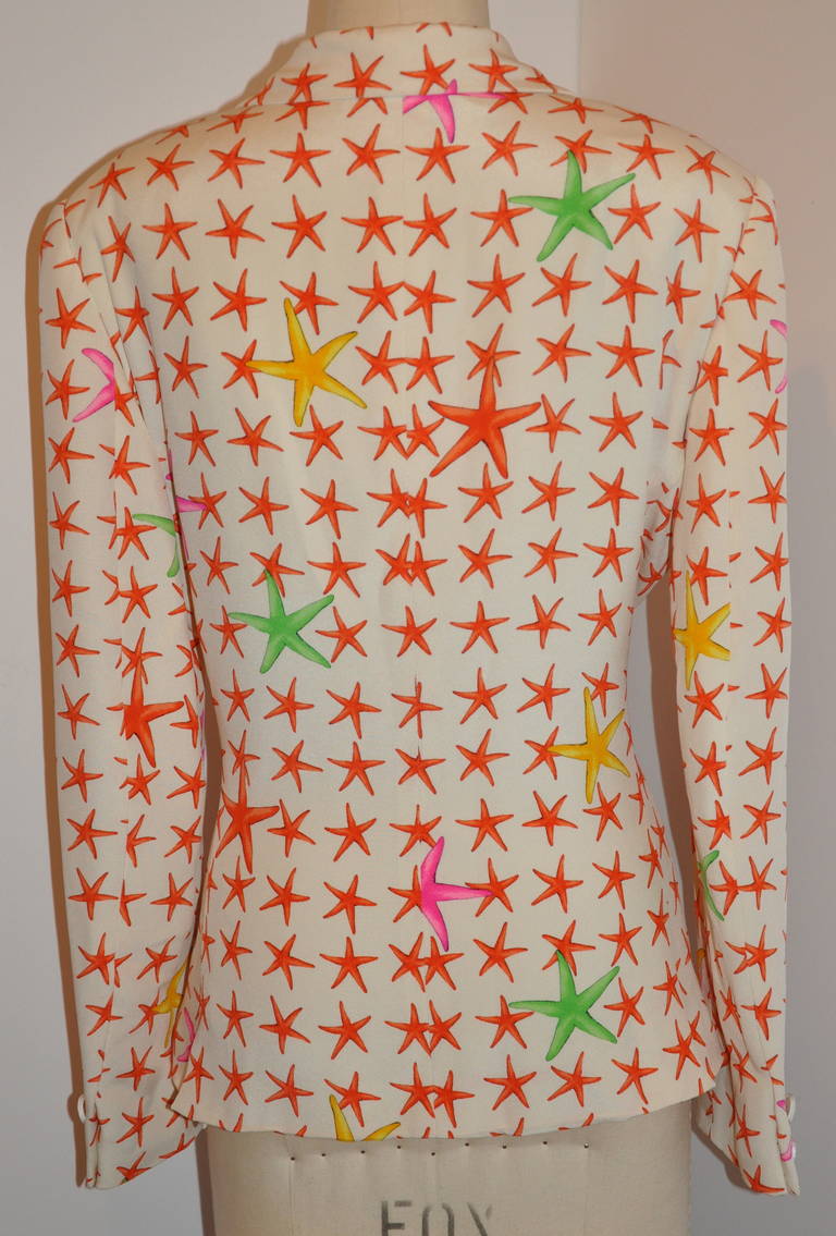 Gianni Versace 'Couture' silk jacket is fully lined with cream rayon with his signature logo. The jacket of creamy silk with coral starfish along with bursts of bold green, yellow and fuchsia starfish. The front has two set-in pockets and detailed
