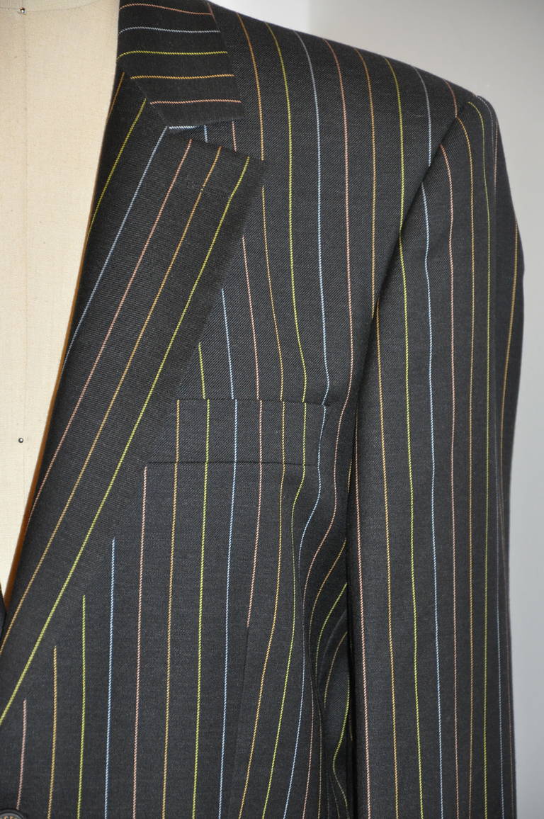 Christian LaCroix's whimisical men's multi-color pinstripe wool pantsuit is fully lined with three whimisical patches along with Christian LaCroix's signature name embroidered within the lining. Made of 100% wool super 110's.The lining of the jacket