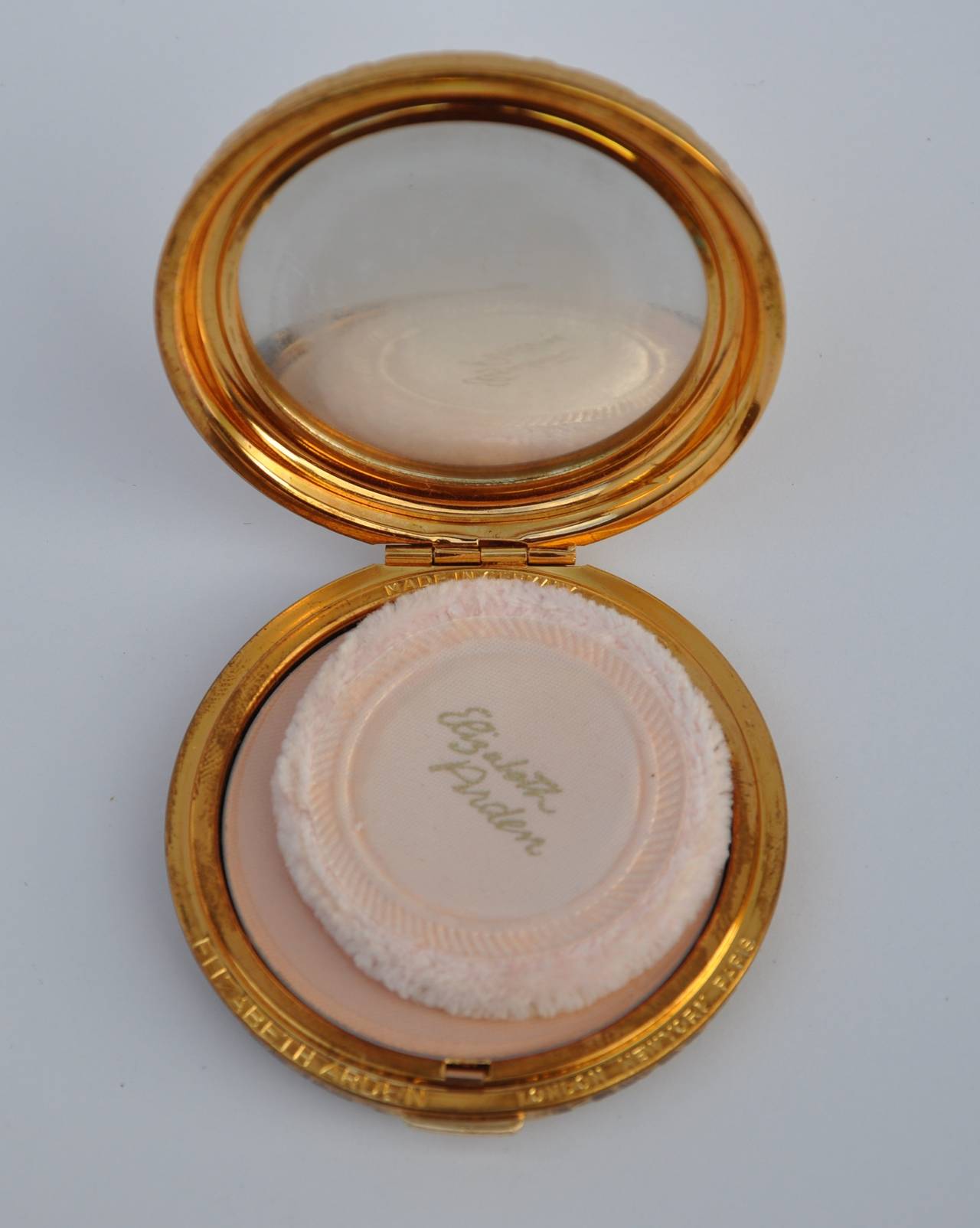 Elizabeth Arden gilded gold hardware made in Germany is accented with a 