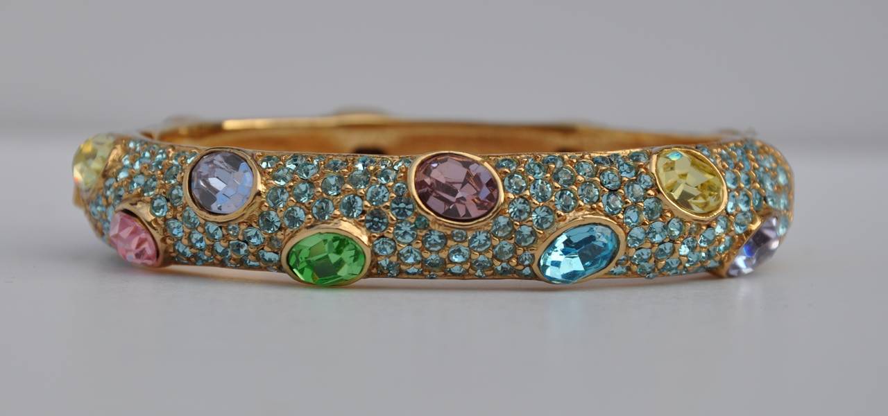 Ciner's wonderfully multi-color and multi-size rhinestone encrusted gilded gold hardware bracelet measures 2 3/4" in width, 2 1/2" in length and  height is 1/2" on the exterior. The interior measurements are 2 3/8" in length and