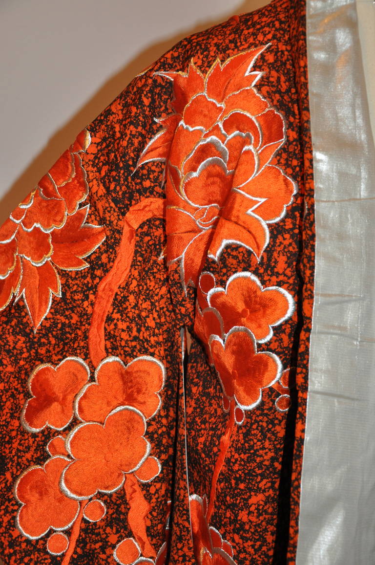 This highly collectable spectacular rare tangerine and black ceremonial kimono has detailed hand-embroidery throughout accented with floral gold lame threads. This ceremonial Japanese kimono is hand sewn and hand-quilted throughout. Fully lined with