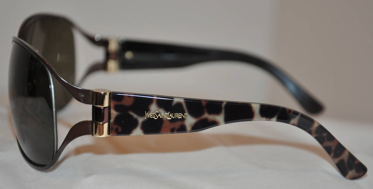 Yves Saint Laurent black hardware frame sunglasses are accented with tortoise shell on the arms. The arms also has their signature 