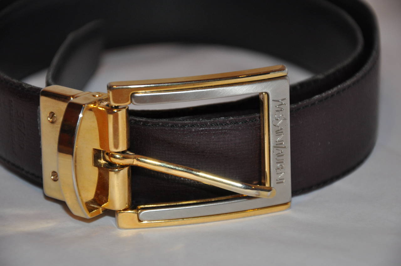 Yves Saint Laurent men's reversible calfskin with gold hardware belt has the choice of either a black calfskin or a brown calfskin to match the signature gold hardware with Yves Saint Laurent signature name etch onto the hardware.
   The bely