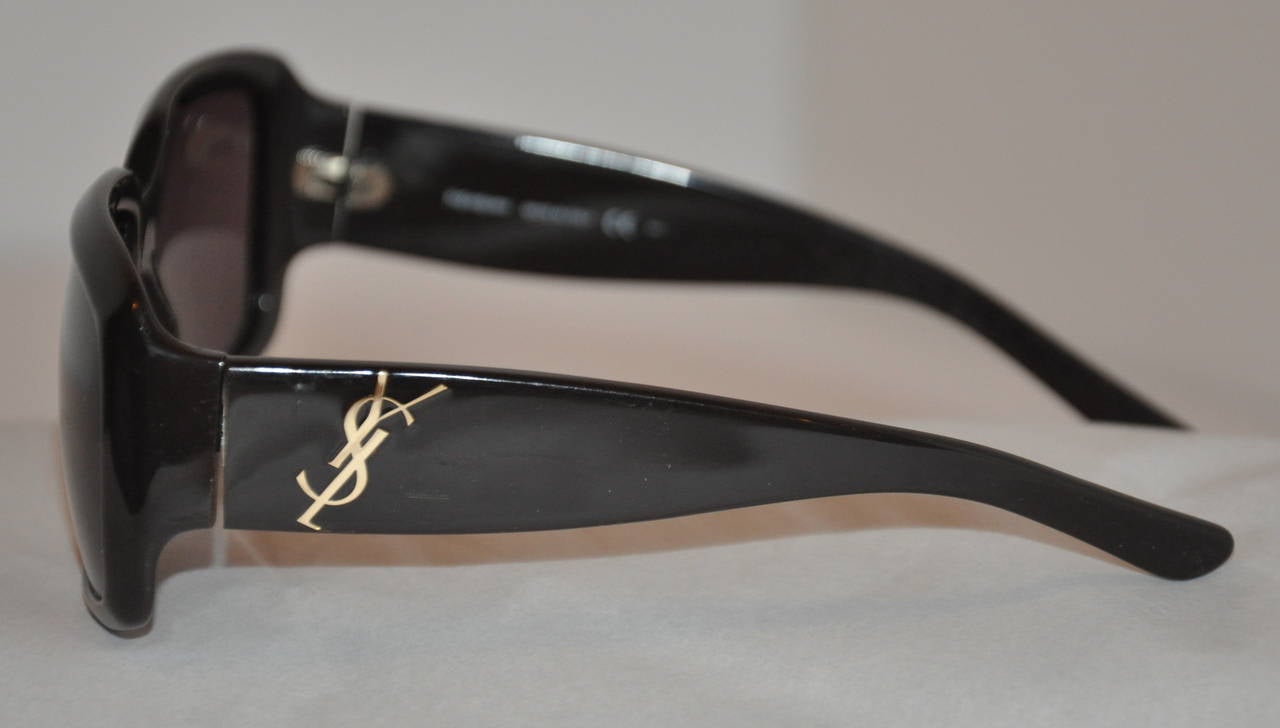 Yves Saint Laurent thick black lucite sunglasses are accented with his signature 