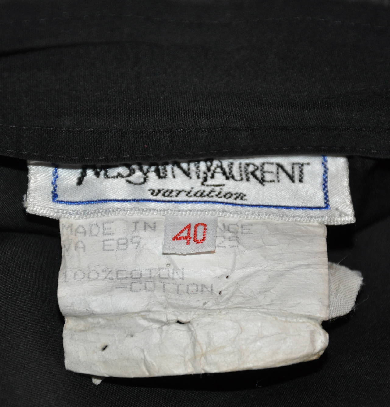 Yves Saint Laurent black cotton skirt is accented with his signature engraved 