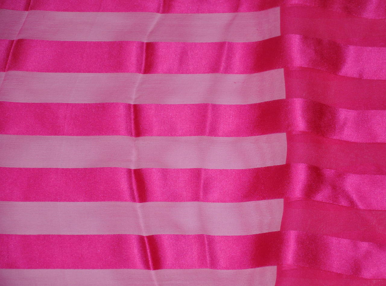 This wonderfully festive bold fuchsia crepe de chine with silk chiffon combination is set in a stripe design and finished with hand-rolled edges. The scarf measures 11 1/2