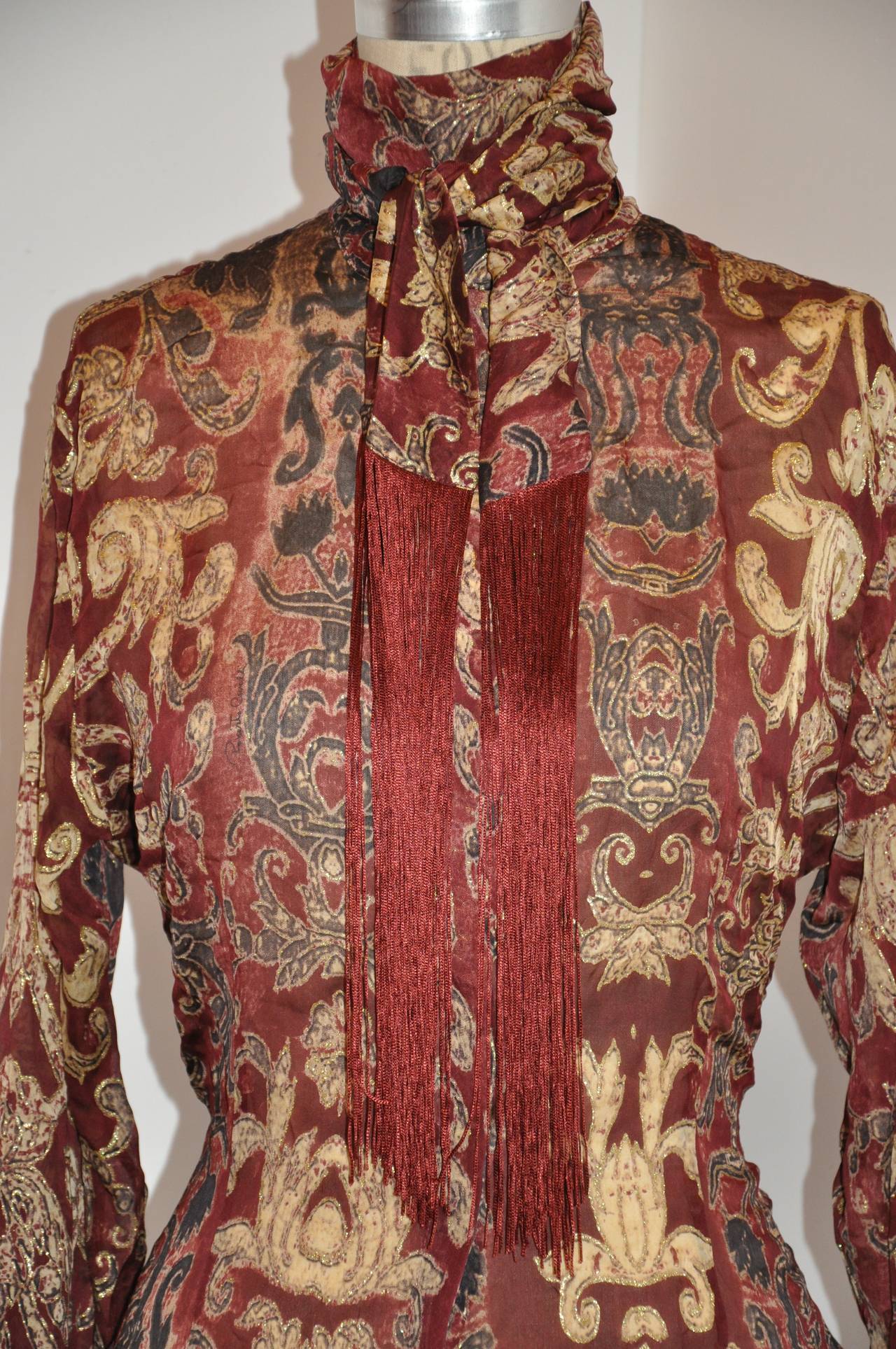 Roberto Cavalli silk chiffon blouse is etched throughout with gold lame. The collar, which stands at 3 5/8