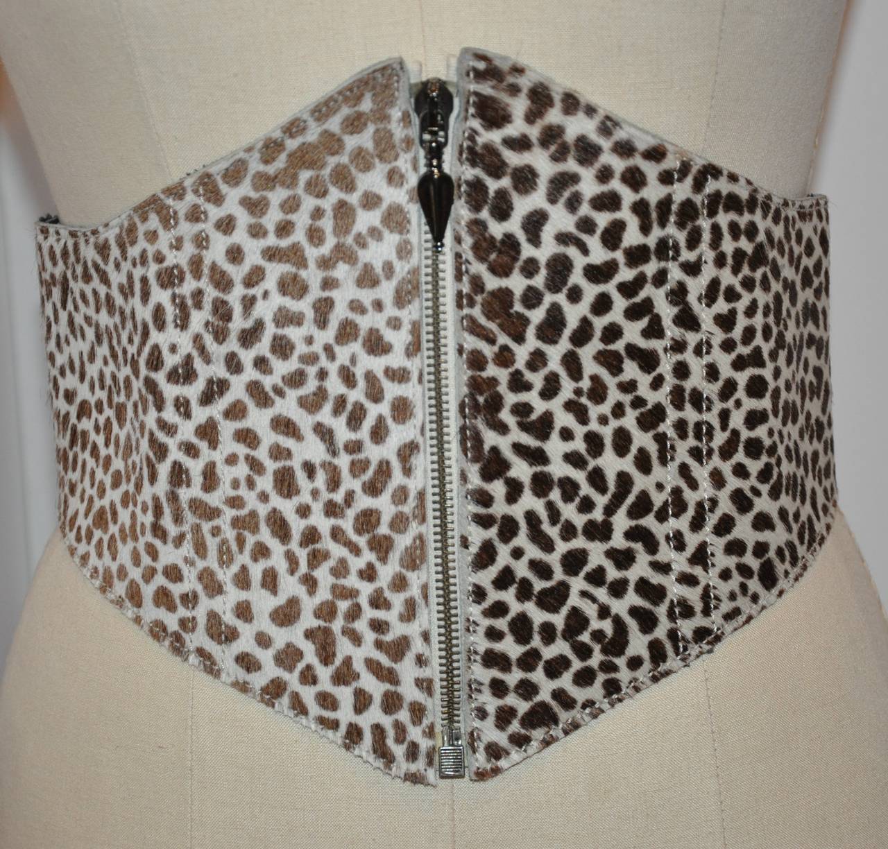 Ozbek leopard print in colors of browns and cream. Pony-skin zipper belt is fully lined with black leather. The widest width measures 8 1/2