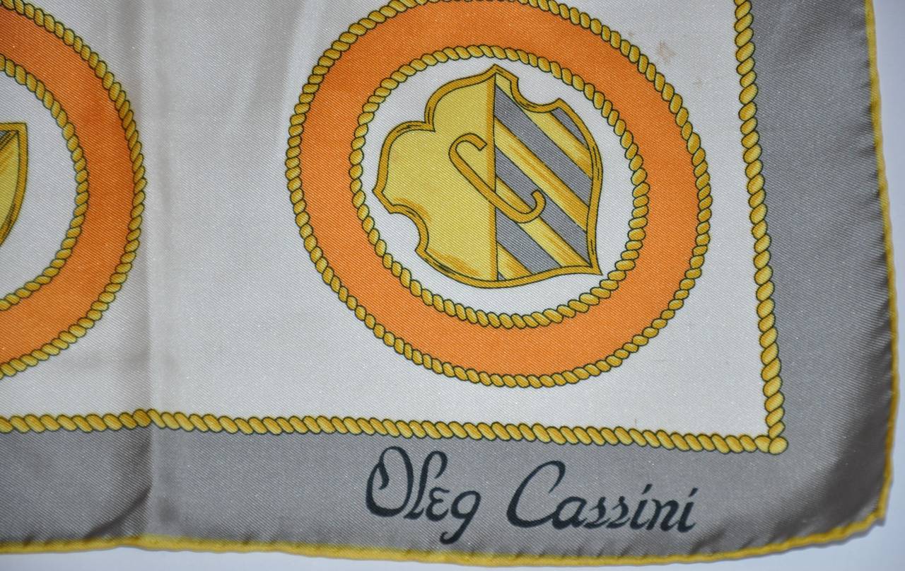 Oleg Cassini signature silk scarf is finished with hand-rolled edges and measures 31