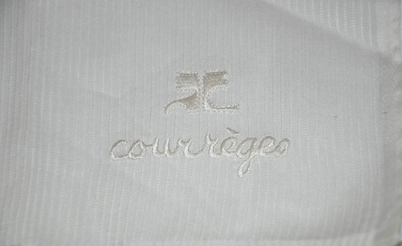 Courreges white handkerchief of 100% cotton from Switerland is accented with hand-embroidery of their signature name along with their signature logo. The handkerchief measures 16