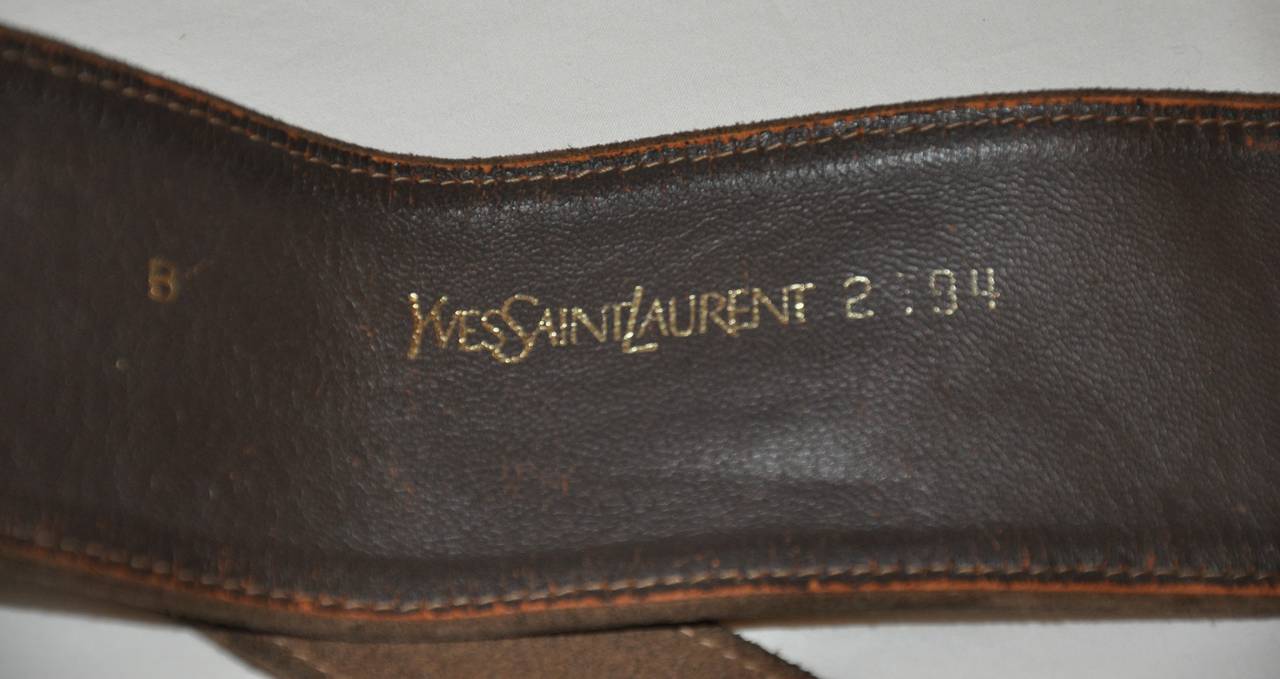 Yves Saint Laurent double-layer taupe calfskin suede is finish with a gun-metal metal hardware buckle. The belt measures 1 1/4 and 2 1/2
