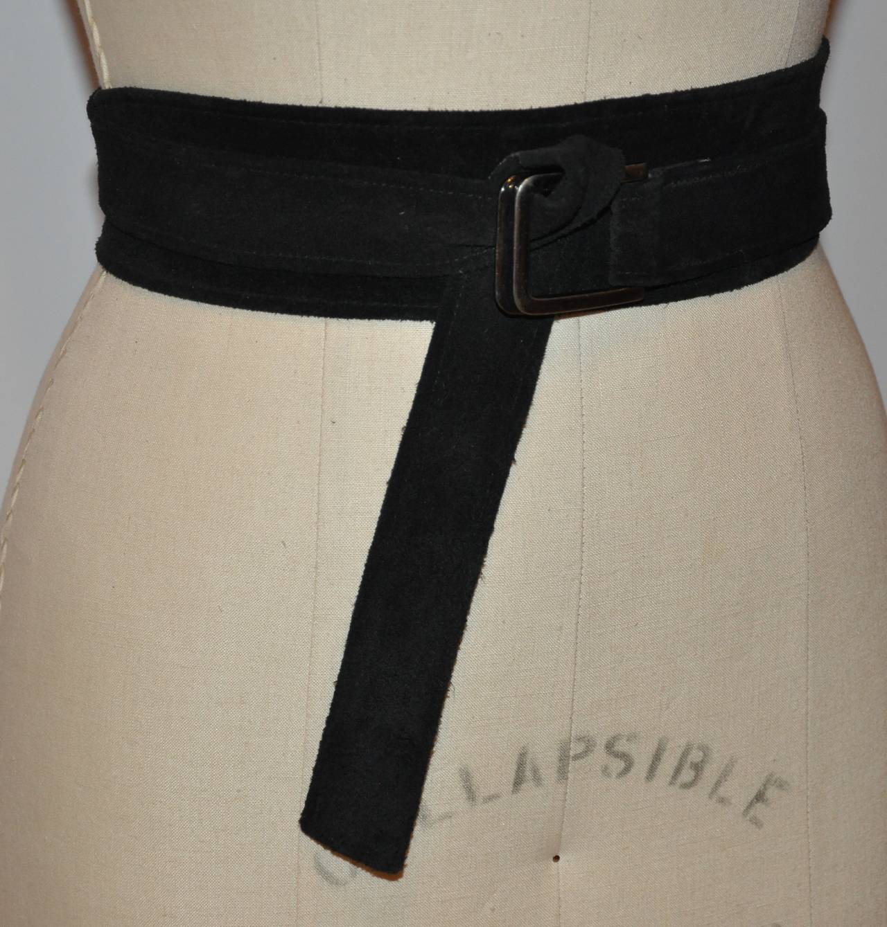 Yves Saint Laurent's double-layered calfskin suede wrap belt is accented with  a steel gun-metal hardware buckle. The belt measures 1 1/4