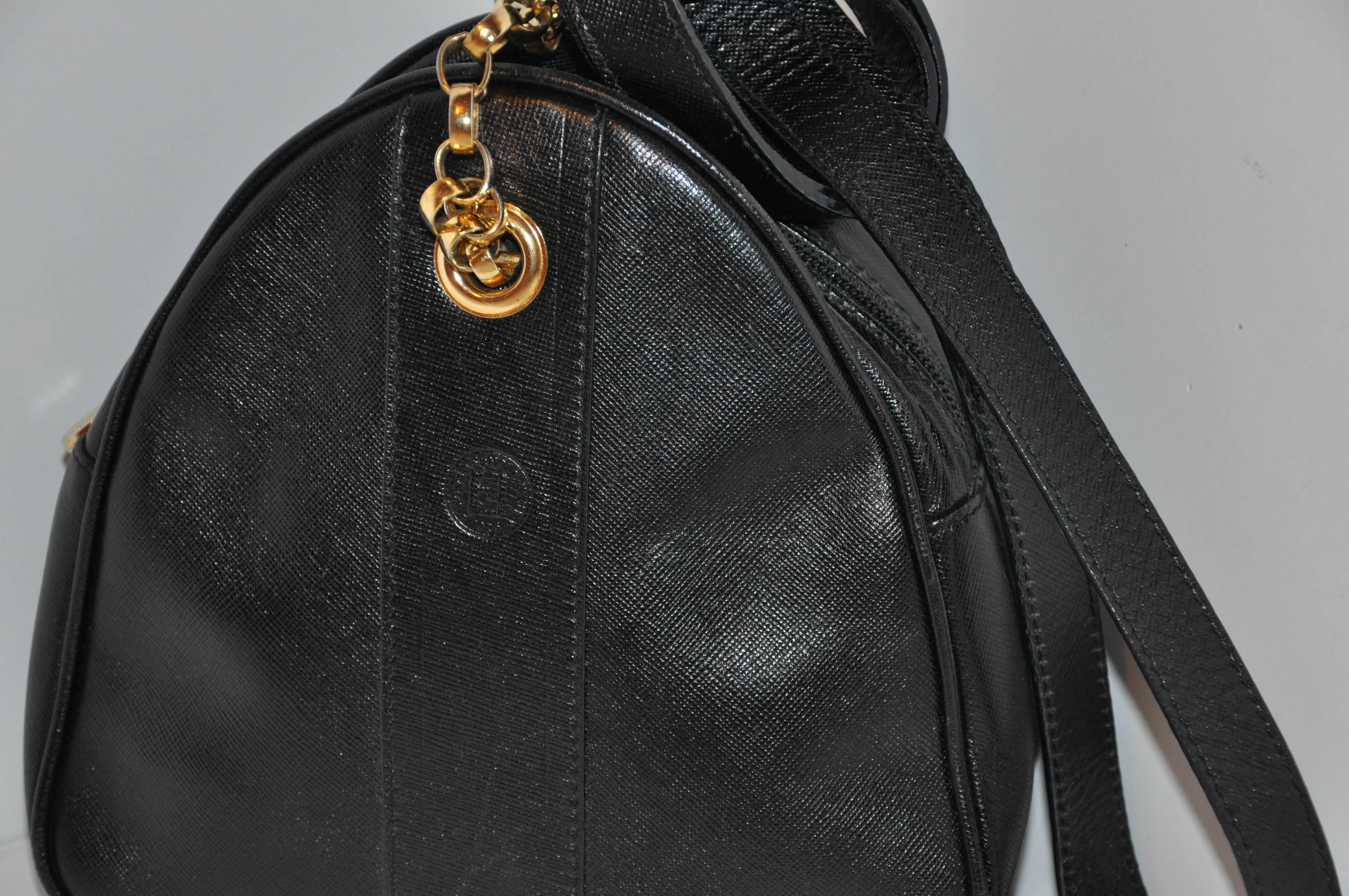         Fendi black textured calfskin leather small shoulder bag is accented with gilded gold hardware on the straps, eyelet and zipper's tab. Their signature name logo is located on the front-side.
        The interior is fully lined and the top