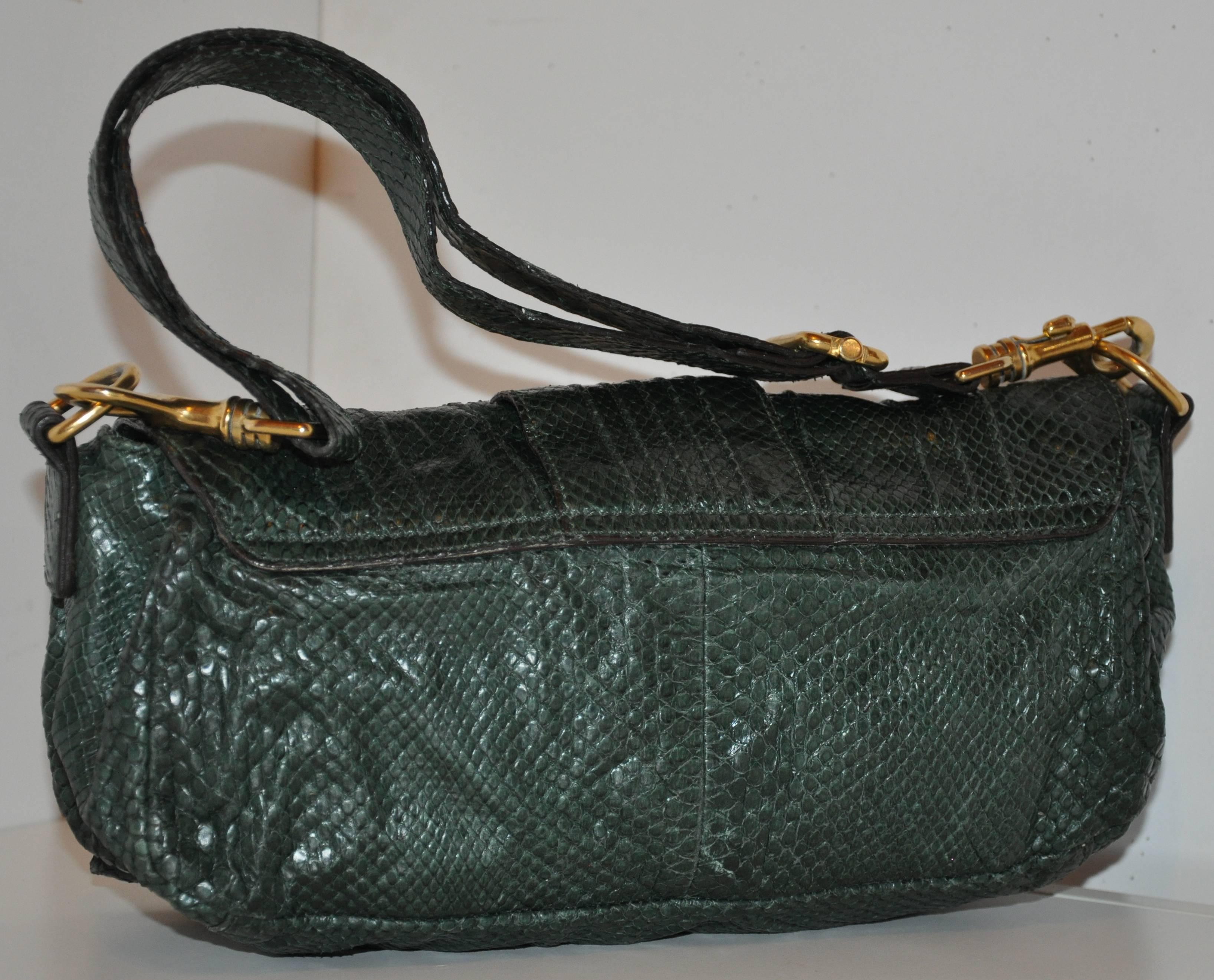           Escada's wonderfully detailed forest green lizard skin flap-over shoulder bag is accented with removable shoulder straps for used as a clutch if desire. The shoulder straps are adjustable measuring 1 1/8" x 31". There are three