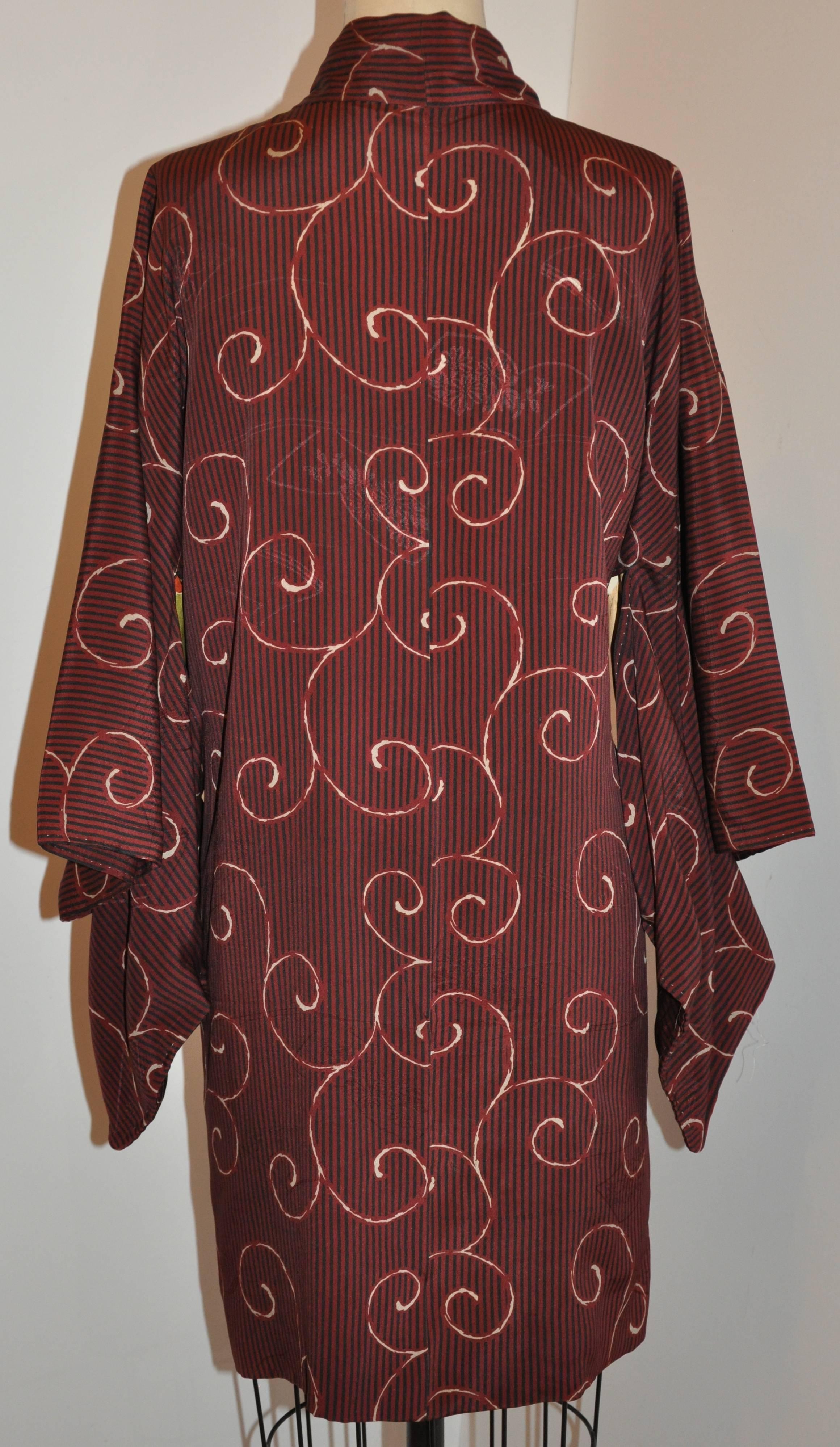          This wonderful Japanese silk kimono is combined with swirls and stripes within the warm burgundy silk. The interior is combined with multi-colors print of clouds as well as the exterior swirls and stripes print.
        The total length