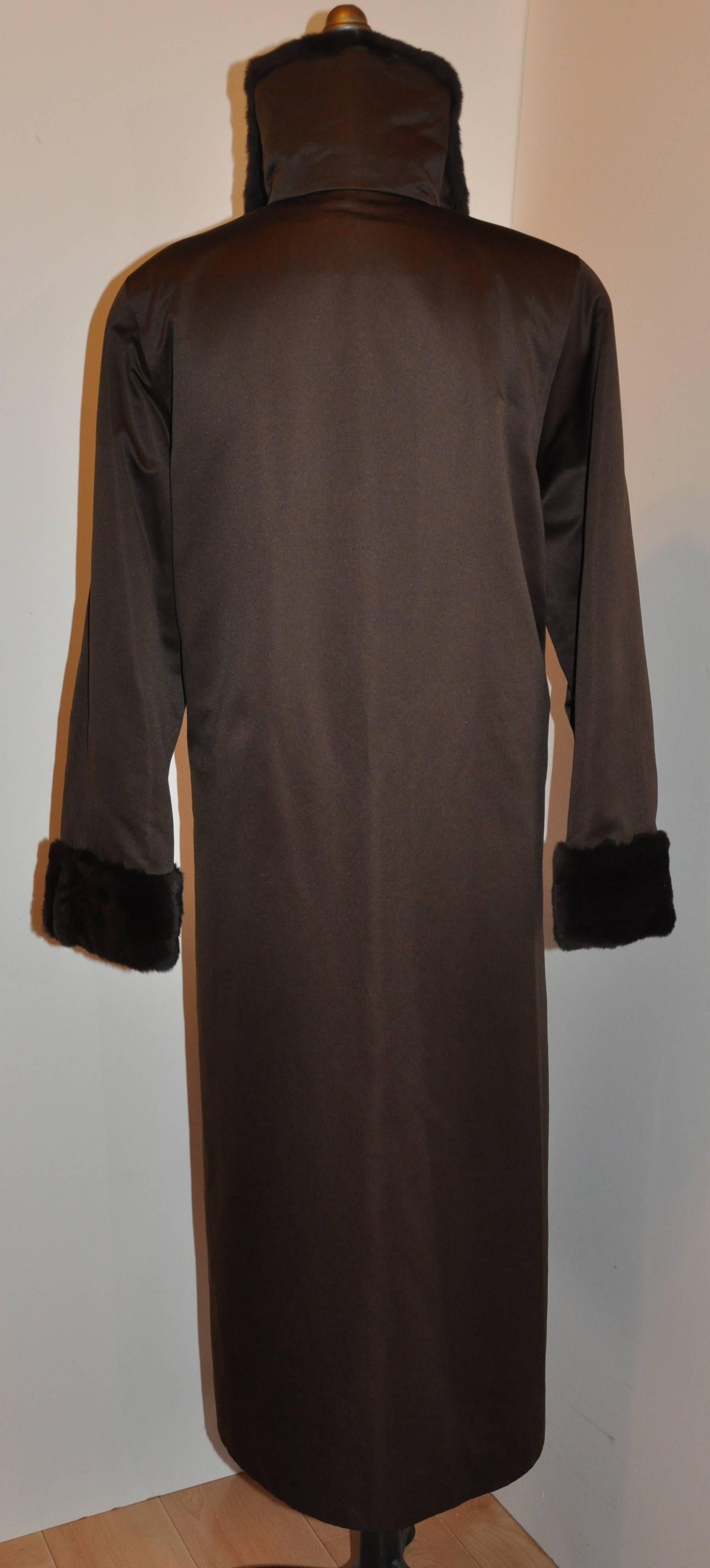       Lowenthal's wonderfully classic, timeless and elegant coco-brown silk satin evening coat is actually a four-season coat with it's detachable female-skin sheared mink lining. The silk satin coat is of a medium weight along with it's own