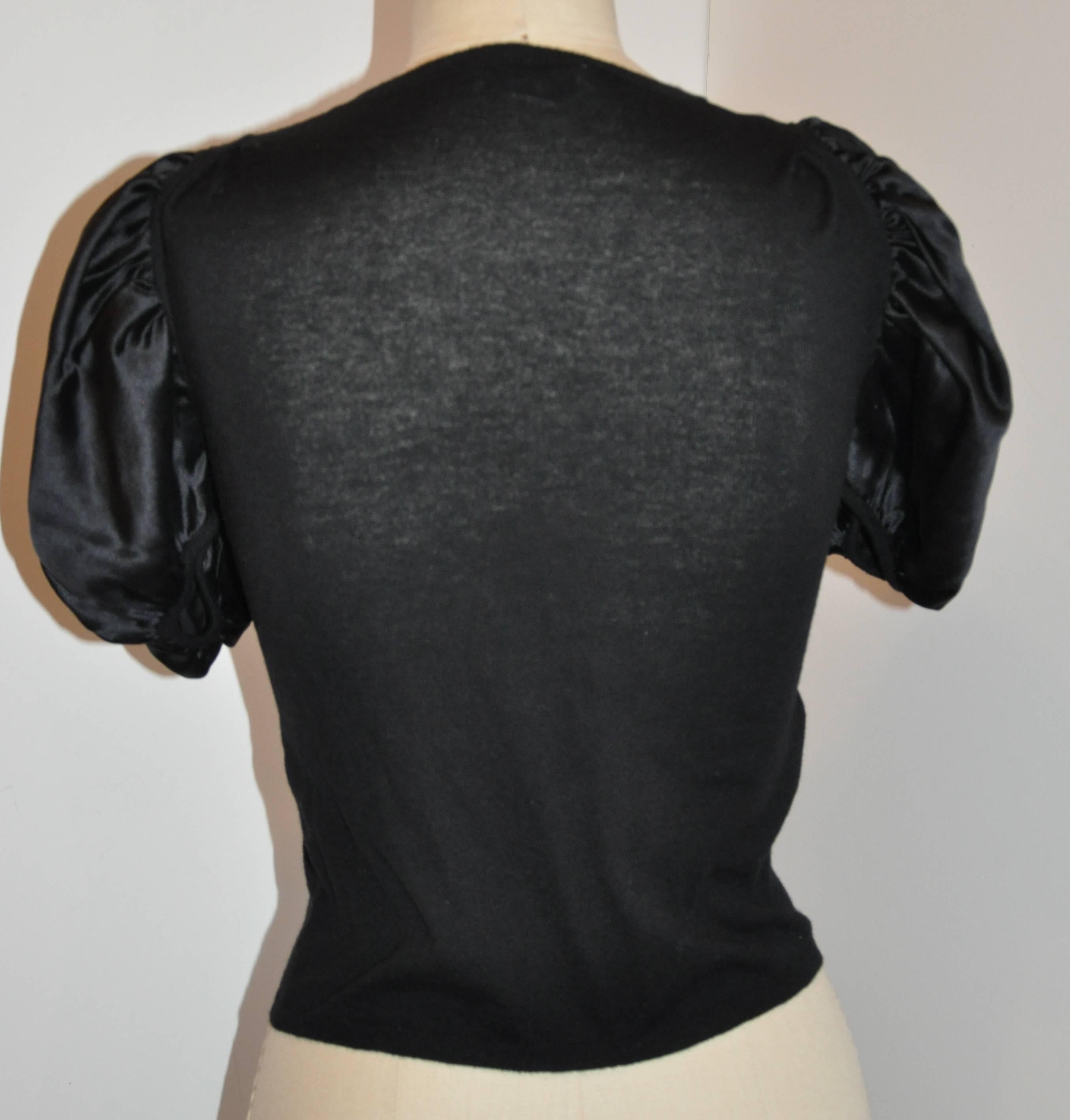         Prada's wonderfully elegant black silk with wool & cashmere blend crew neck pullover top measures 11 across the shoulder. The underarm circumference measures 34
