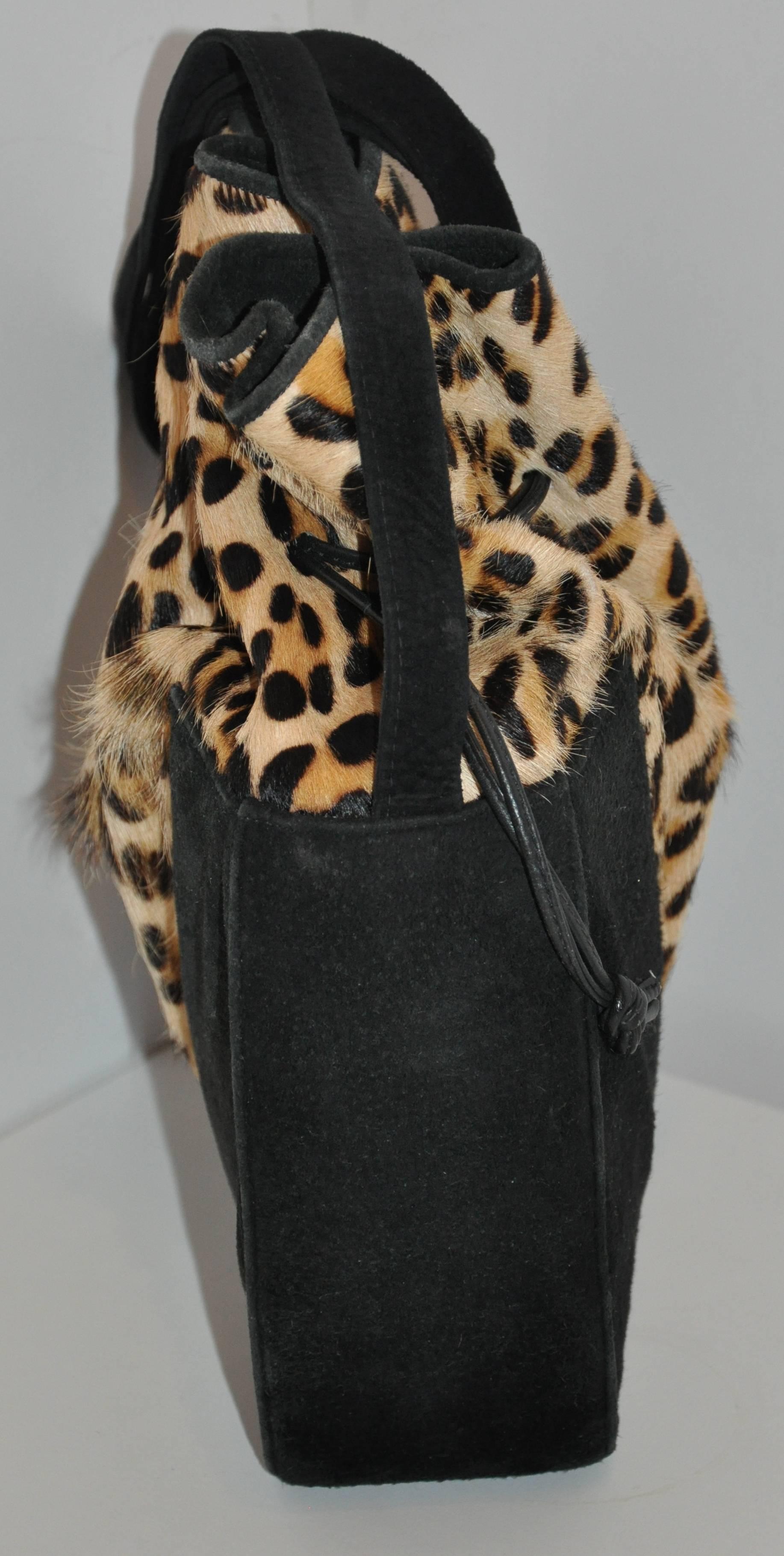            Gino black suede & leopard print stamped pony-skin hobo-style shoulder bag is fully lined with black. The height of the bag measures 12", length is 10 1/8", depth is 3 1/4". The shoulder straps stands at 20 1/2" in