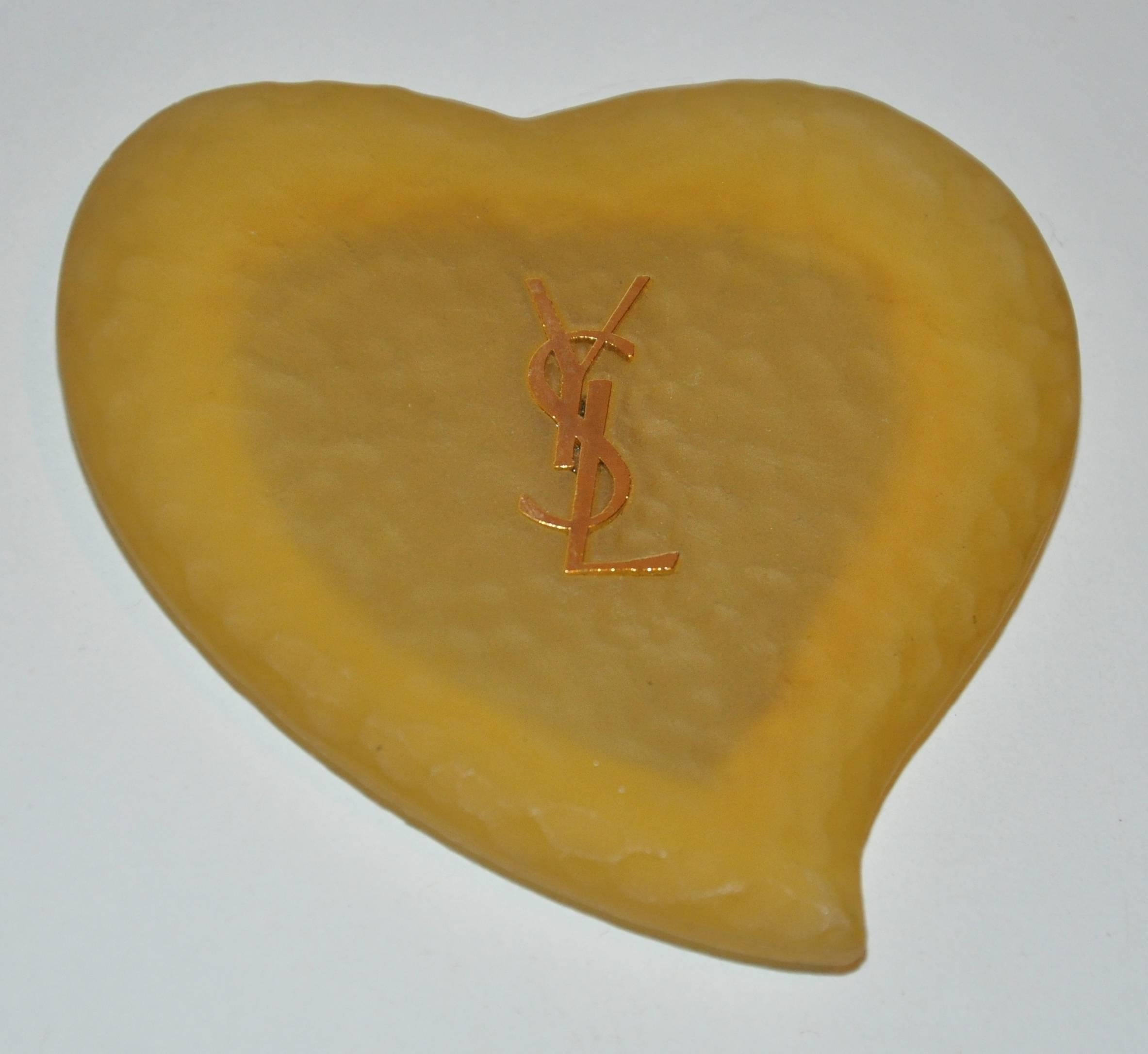         Yves Saint Laurent yellow lucite accented with gold etching "Heart" mirror measures 3 1/4" x 3 1/2" with a depth of 3/8". Made in France.