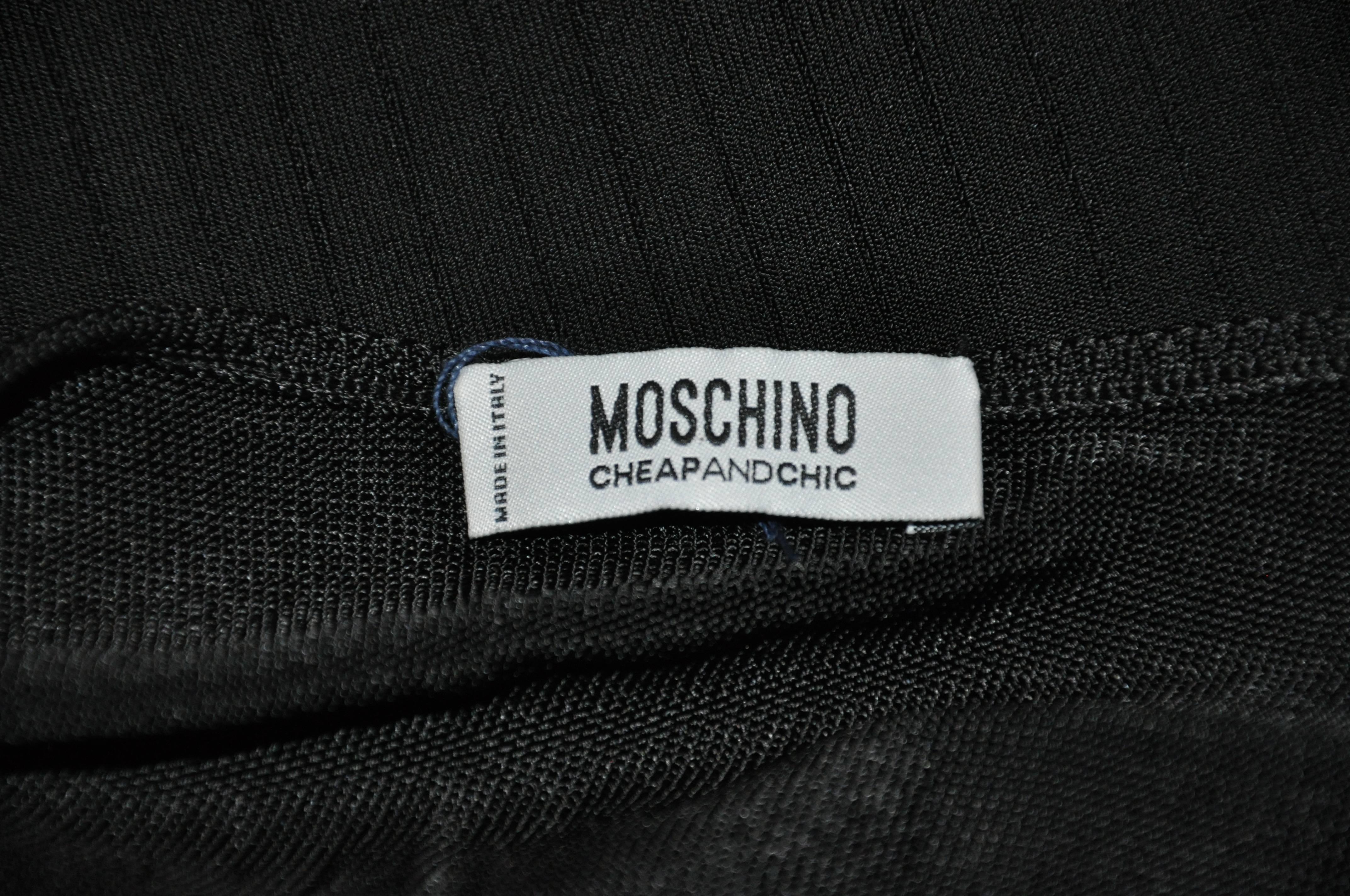         Moschino wonderful sexy body-hugging black stretch knit tank top is detailed with micro-lace hem-line. The length of the front measures 9 1/4