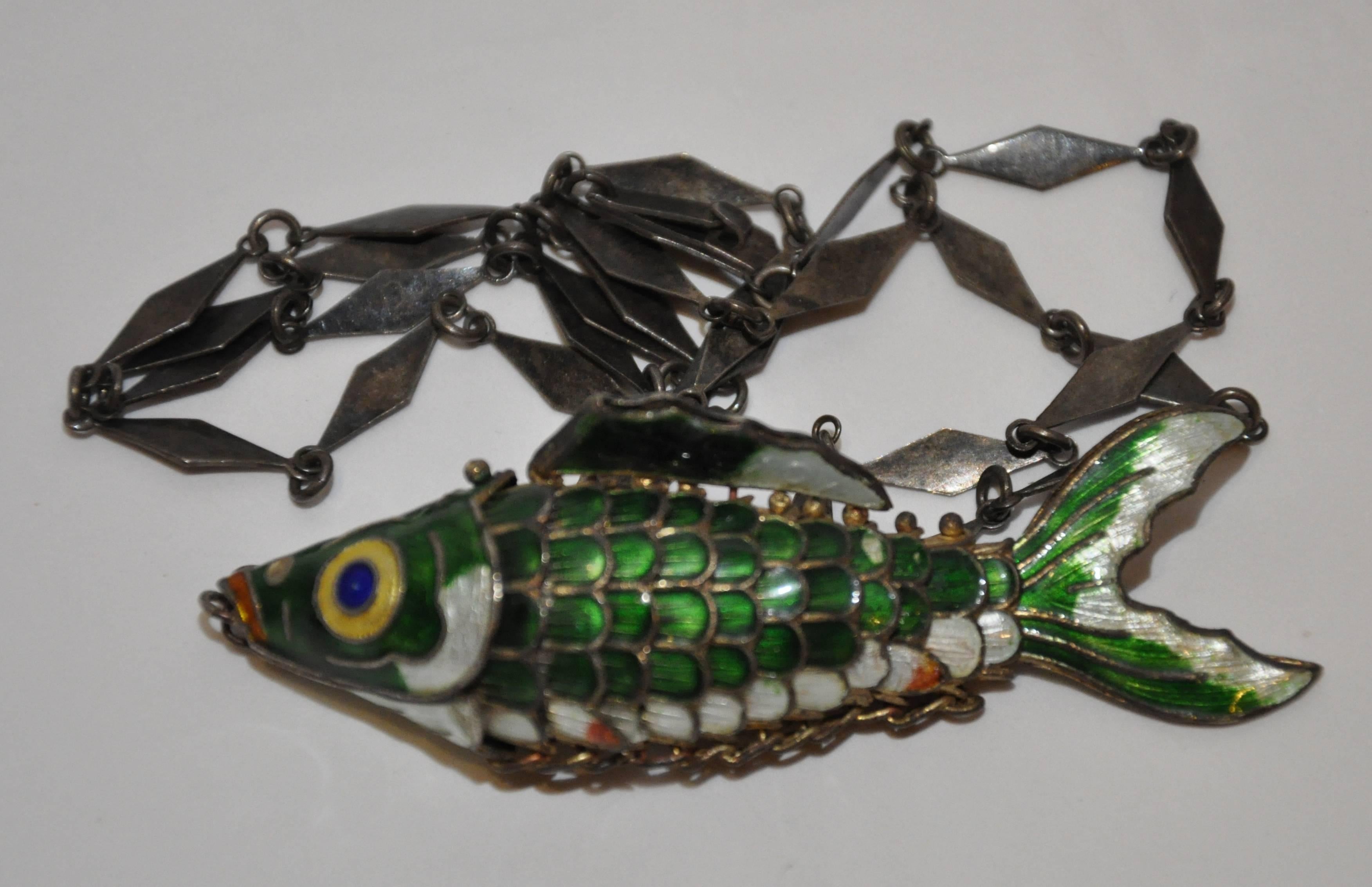        The wonderful multi-colors of greens accented with blue, red and yellow enamel detailed in this moveable enamel Japanese "Carp" is finished with a vintage silver necklace to dangle from. The "Carp" measures 3 1/2" in