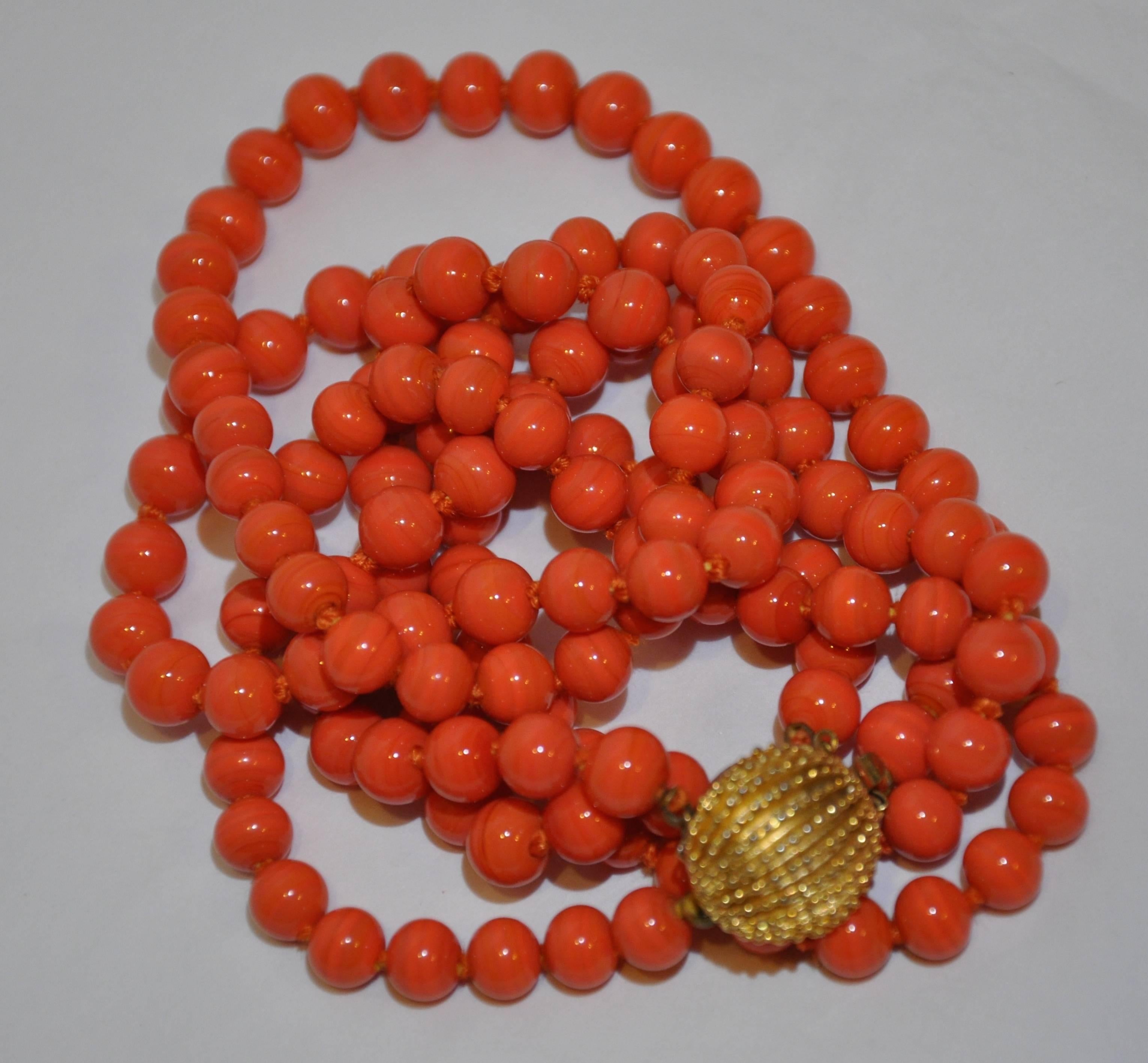        These wonderful natural coral double-strand necklace is hand-knotted accented with detailed engraved gold-tone closing. Of the two strands, one measures 22" in length with the longer strand measuring 24". The total length including