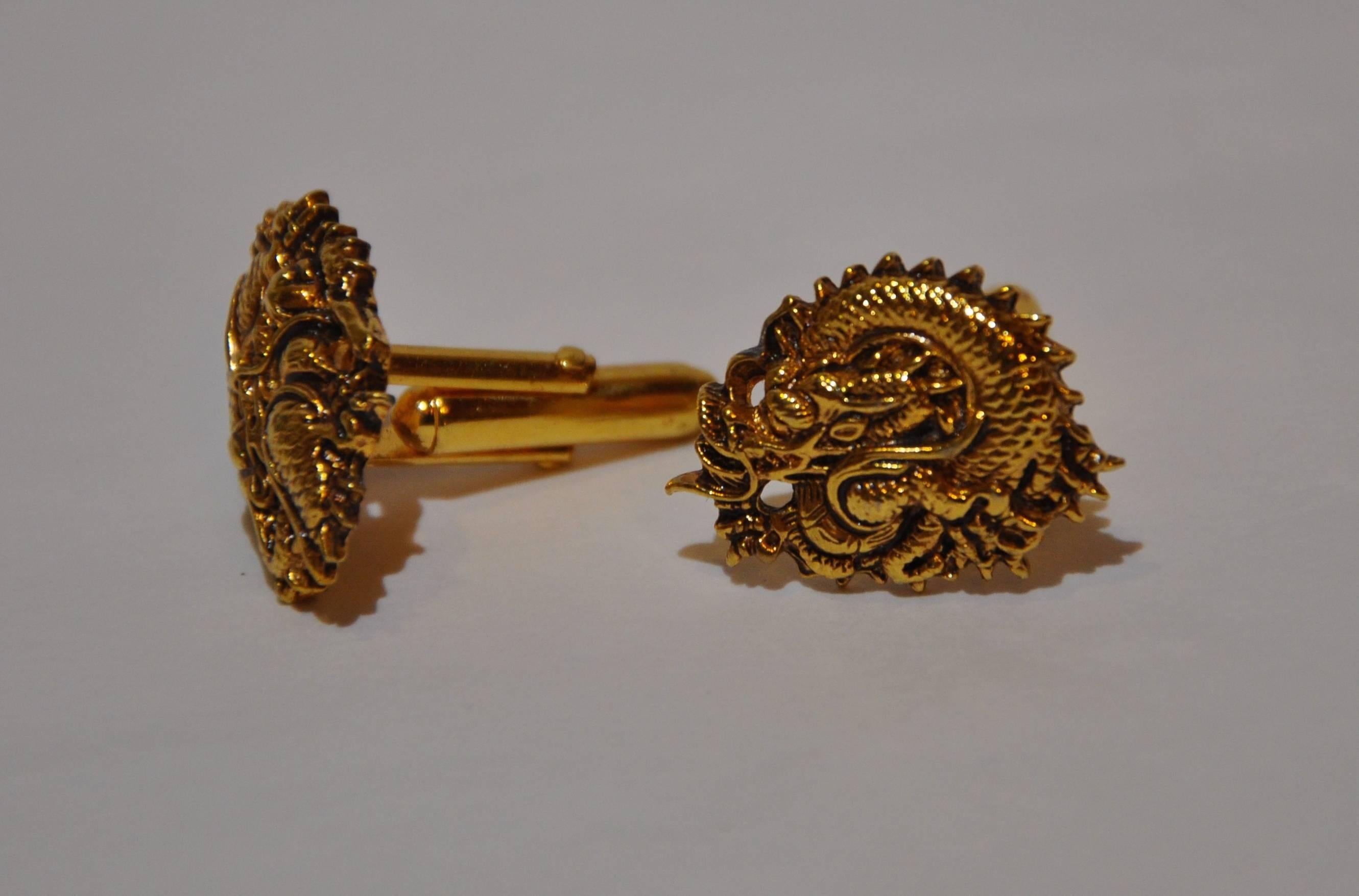        This wonderfully detailed etched cuff links in gilded gold vermeil hardware "Dragon" is etched with multi-textures. Width measures 1", length is 3/4", signed on the back.