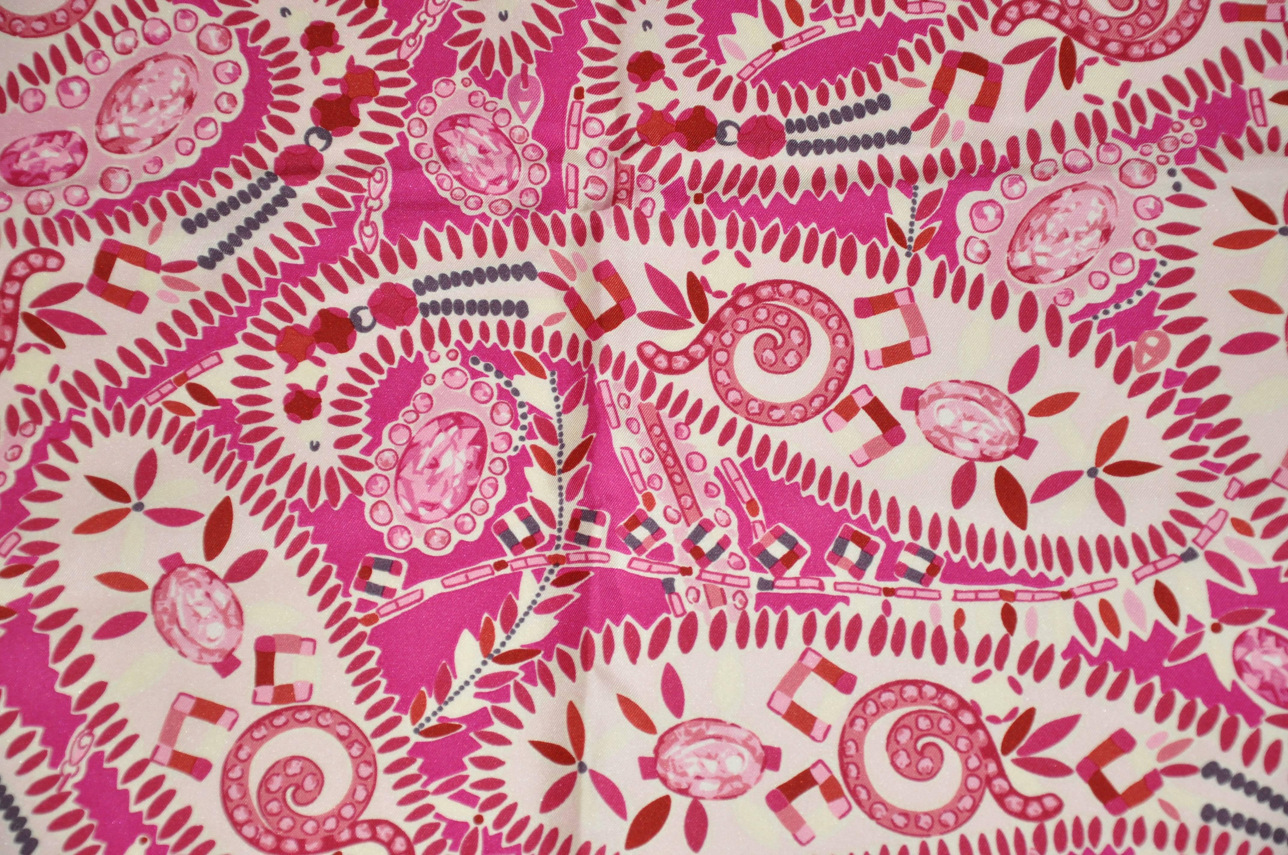         Asprey of London wonderful combination of fuchsia and cream with accents of violet makes for this bold print silk scarf. This wonderful scarf is finished with hand-rolled edges with cream borders. Made in Iatlym it measures 34