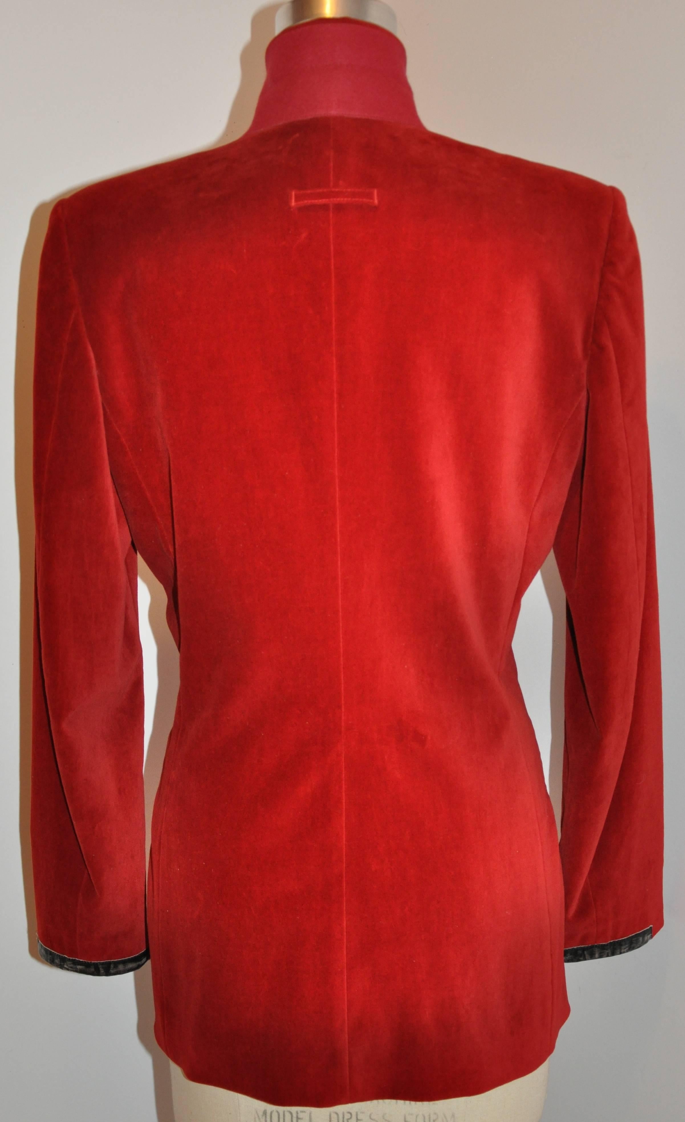           Jean Paul Gaultier wonderfully wicked crimson red brushed cotton velvet jacket is fully lined and detailed with distressed leather within the pockets, collar and cuffs.Underneath the collar is detailed with felted wool as well as a single
