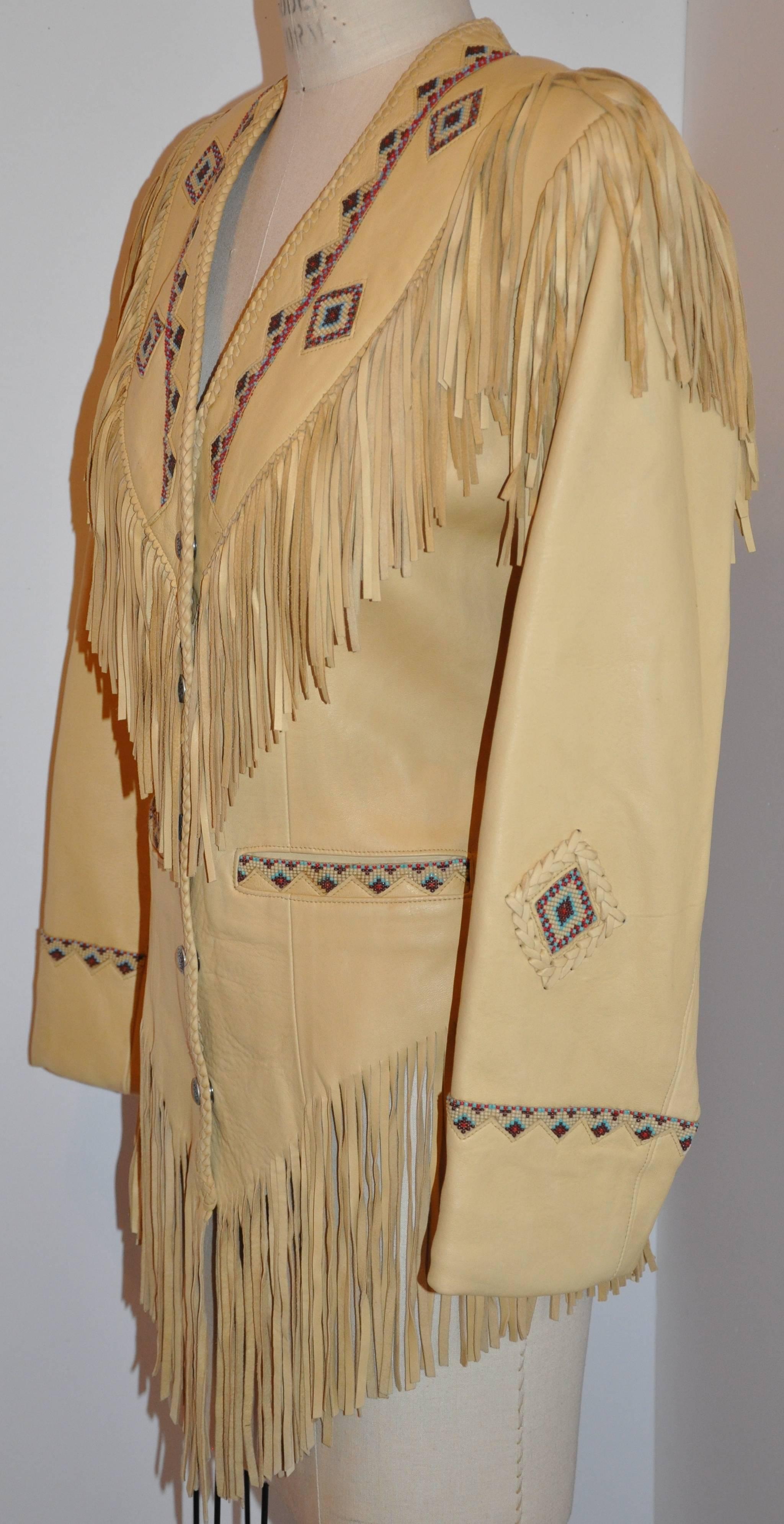       This wonderful detailed West of Santa Fe fully-lined hand-made butter-soft chamois lambskin jacket has details such as hand-done bead-work, hand-cut fringes measuring 5