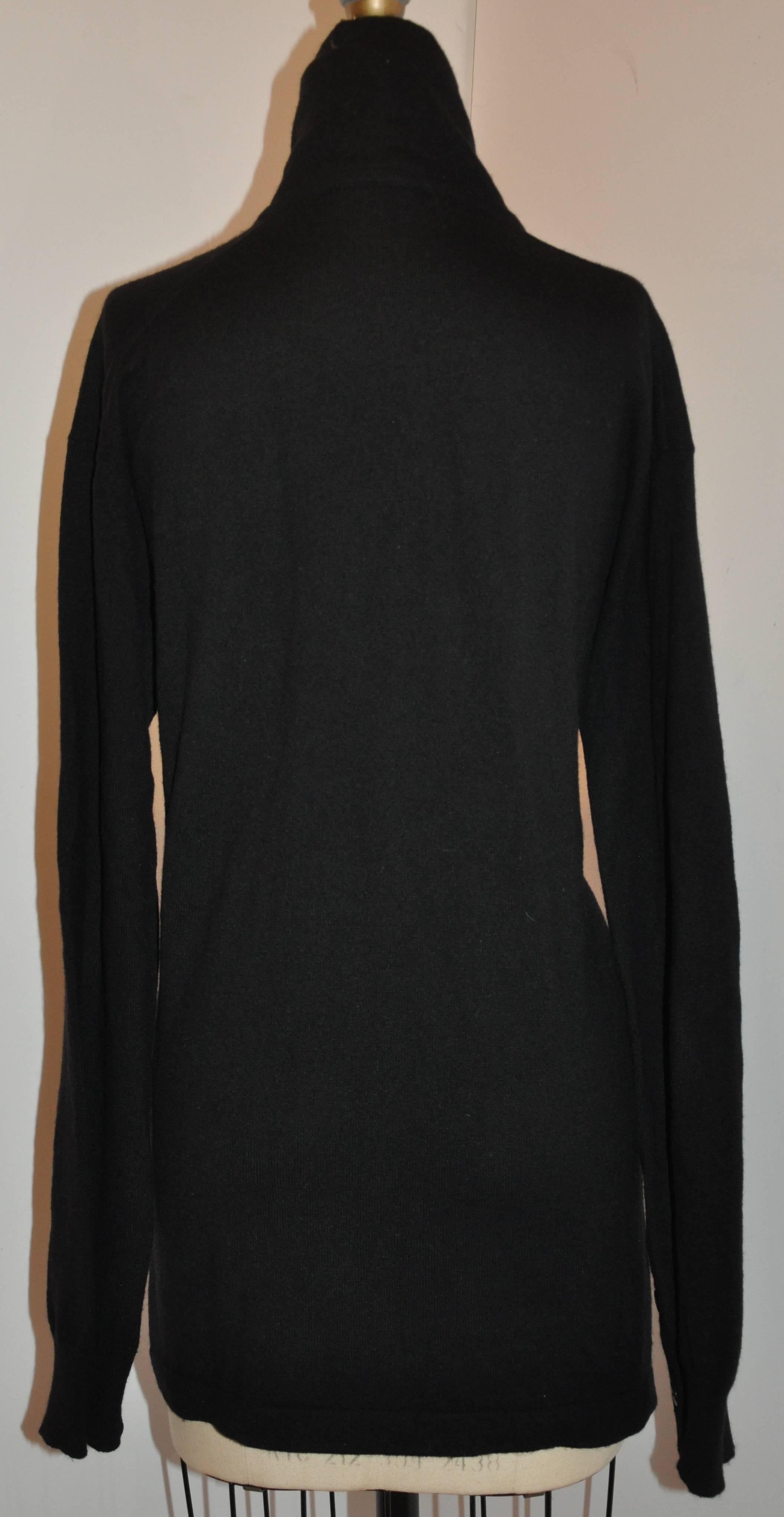           Donna Karan's wonderfully soft black Scottish cashmere pullover features a deep V front combined with a wonderful cowl neck collar which measures 5