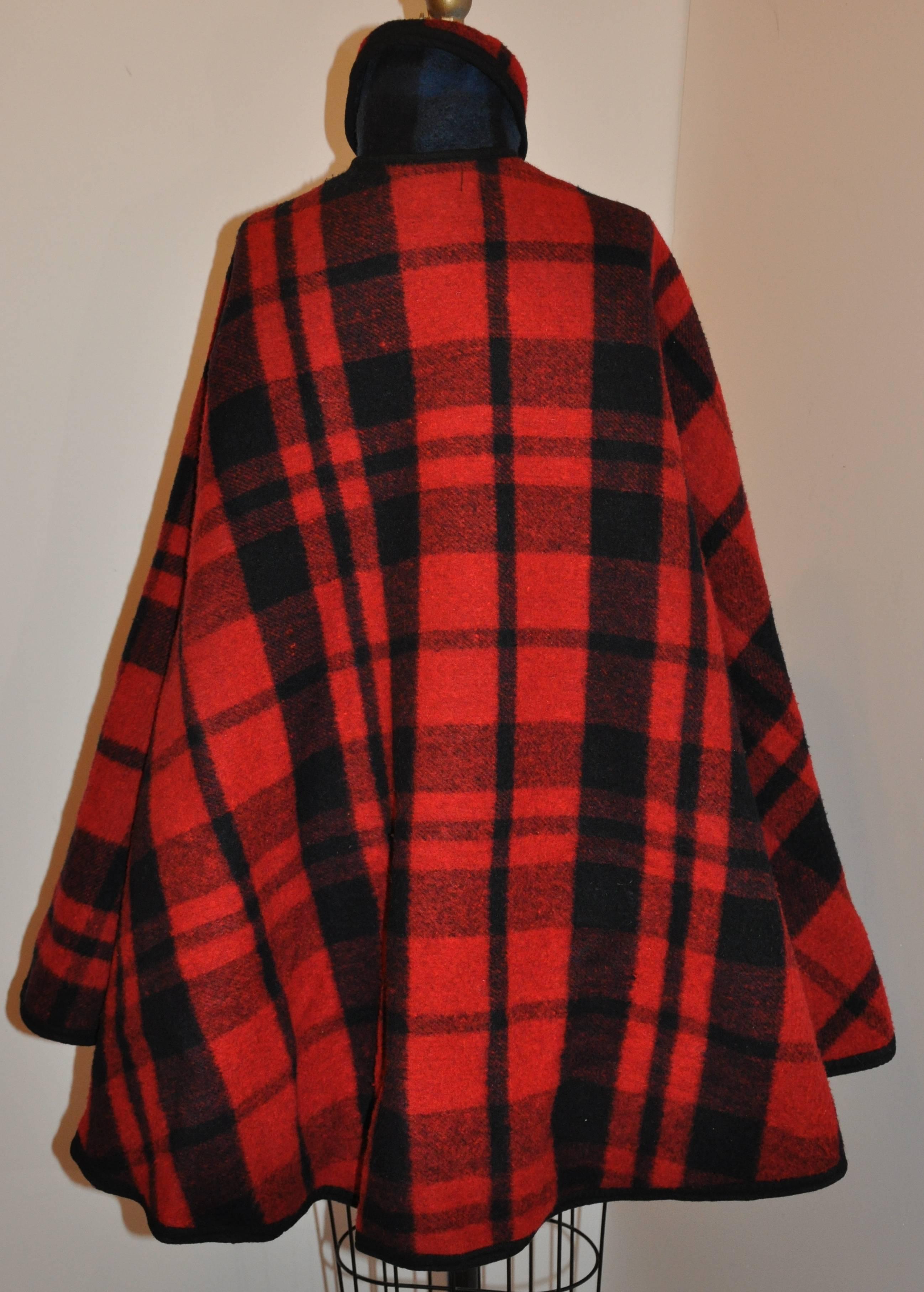           Pendleton's wonderful double-faced reversible plaid poncho makes for a wonderful two-in-one poncho. One side is combined with red & black plaid, with the other side a navy & black plaid. All edges are finished with cording and well