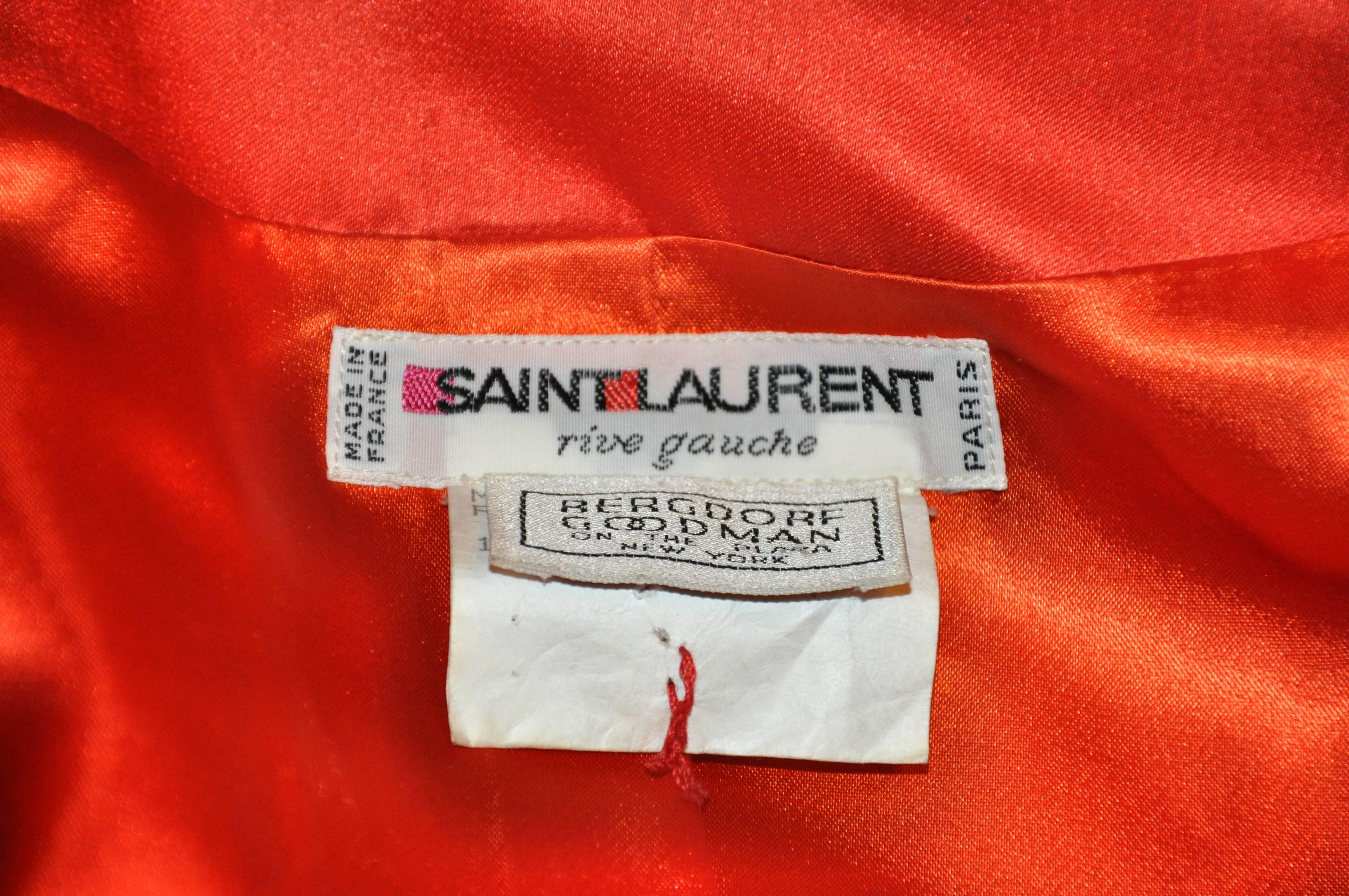          This extremely rare Yves Saint Laurent bold red silk satin cocktail blazer is embellished with 