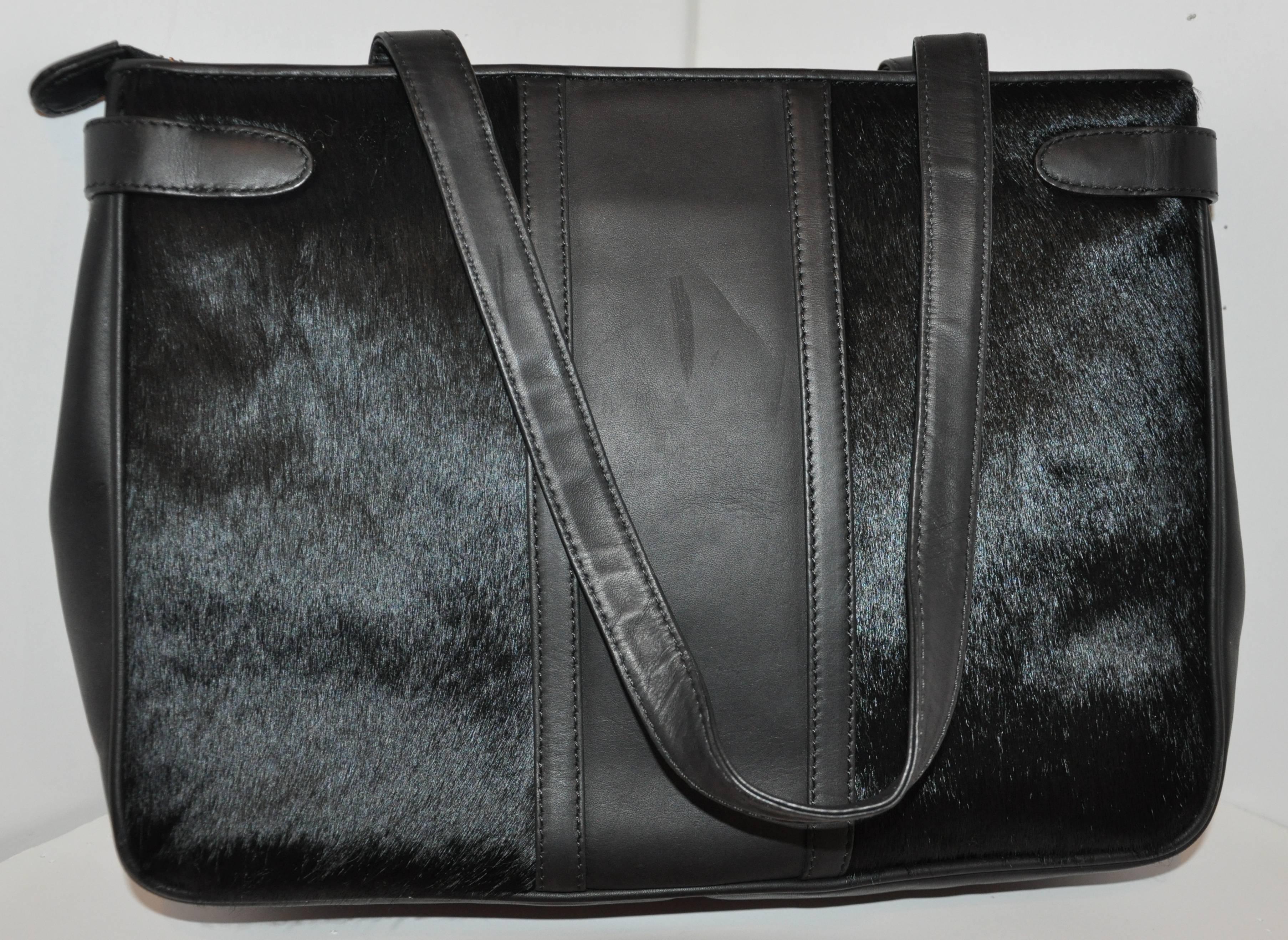         Roberta di Camerino wonderfully detailed black calfskin double-handle handbag with accented with brushed pony skin. The center-front is embossed with their signature logo. The handbag is detailed with vermeil-finish gold hardware as well as