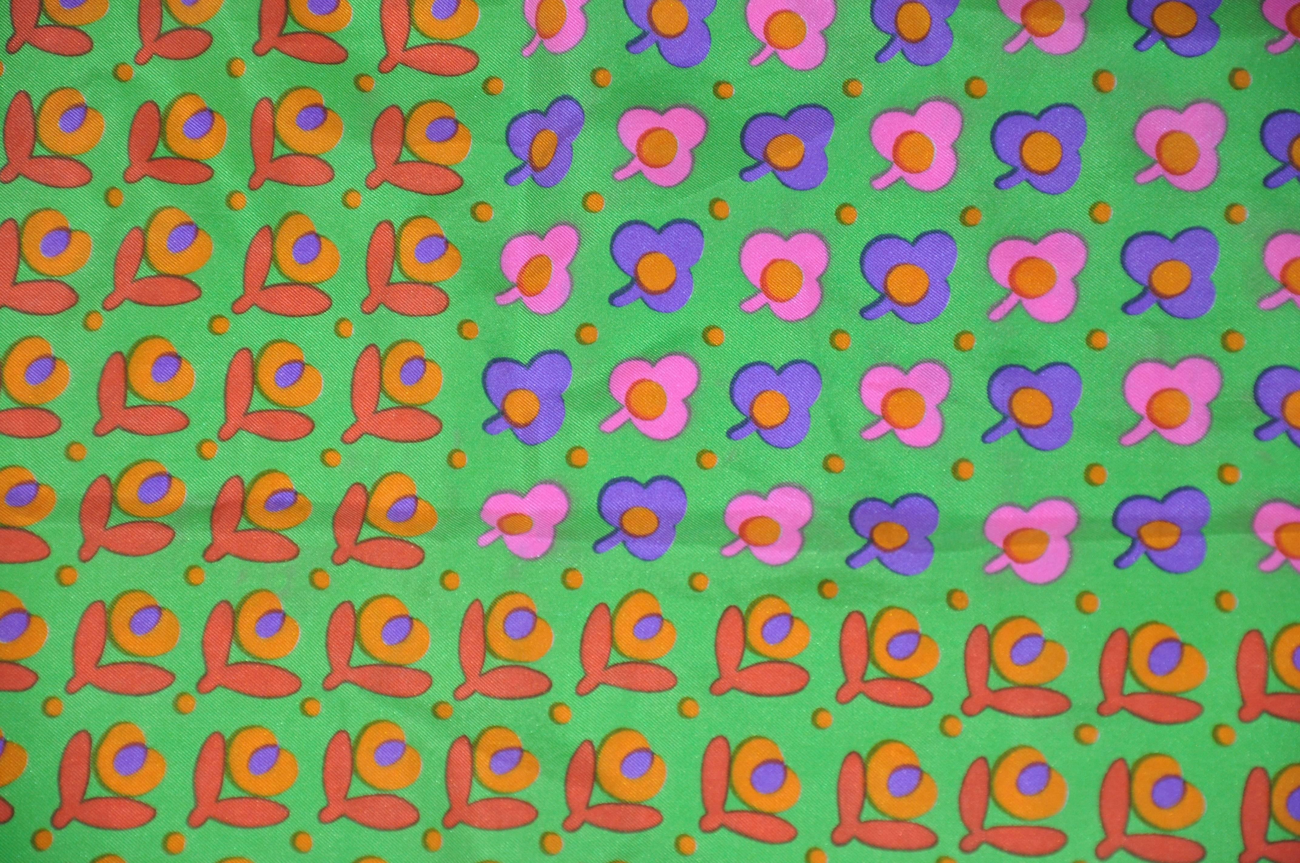        Yves Saint Laurent wonderful multi-color floral print silk scarf is finished with hand-rolled edges and measures 34