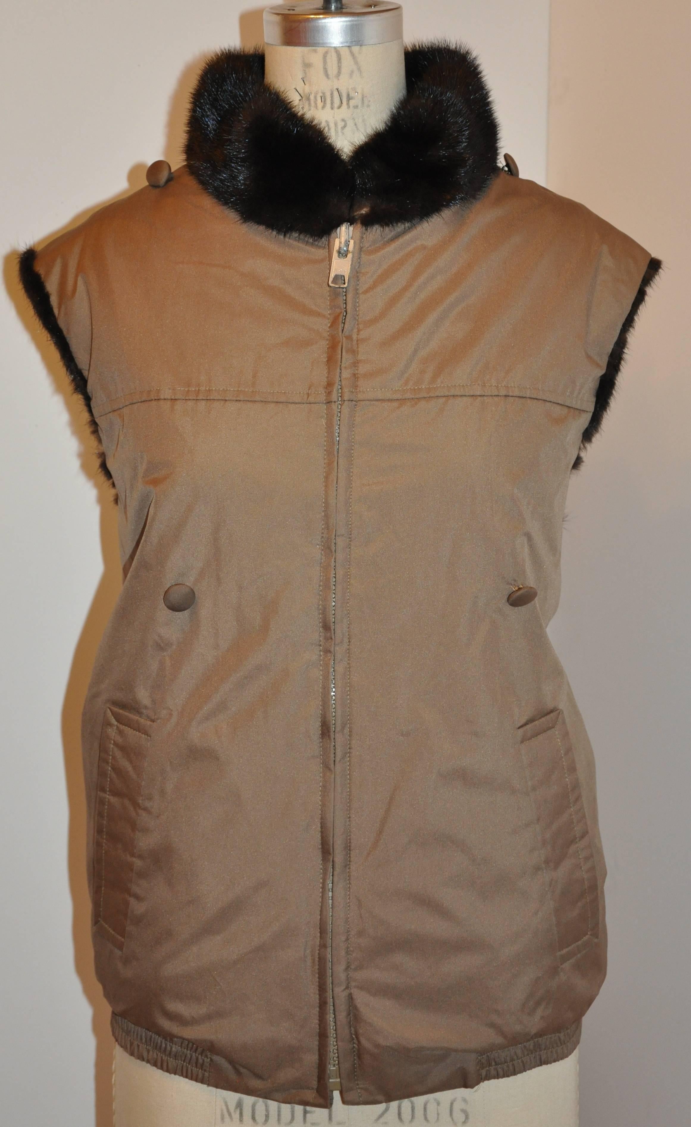        This wonderfully detailed jacket is reversible with mink on one side and waterproof taupe fabric on the other side. The removable sleeves are lined with mink as well. To remove the sleeves, just unbutton and instantly it's a vest when