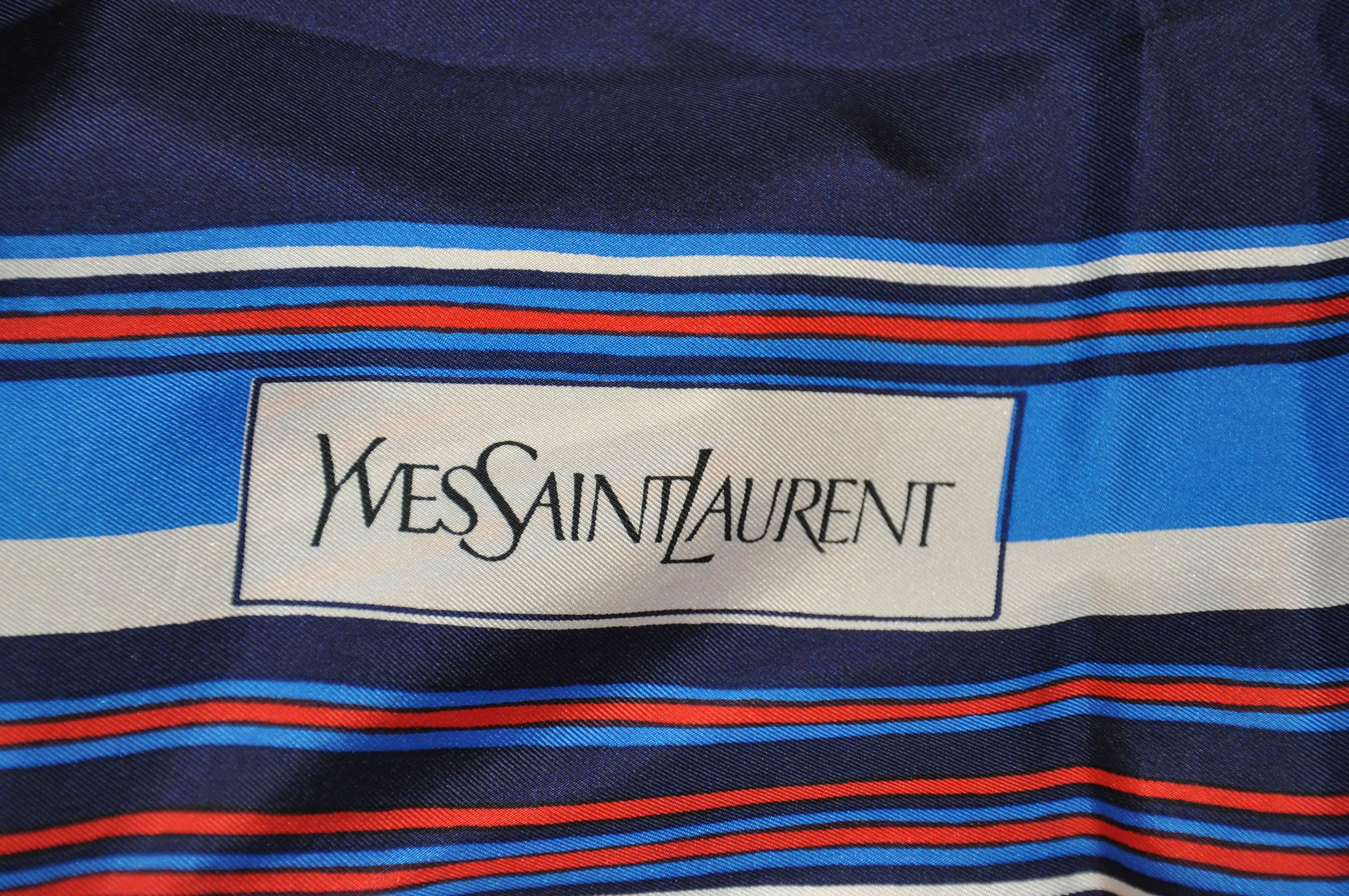         Yves Saint Laurent signature red white and blue silk scarf is accented with the famous logo measures 34